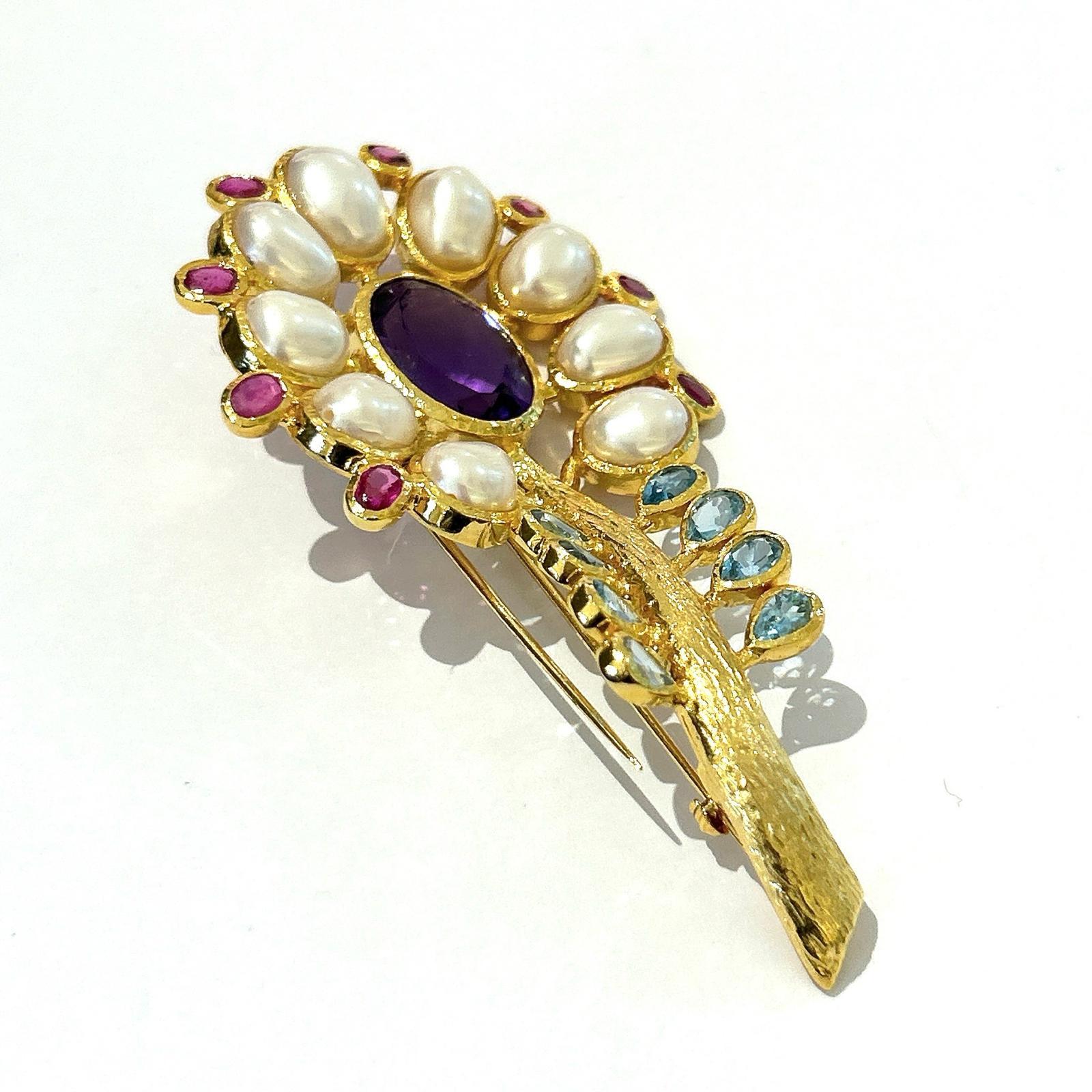 Bochic “Orient” Amethyst, Topaz, Pearl & Ruby Brooch Set In 18K Gold & Silver 

Natural Red Ruby, Oval shape - 3 carat 
Natural Blue Topaz and Ametyist
16 carat
White Button Pearls 

The Brooch is from the 