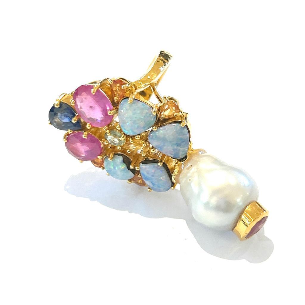 Bochic “Orient” Blue Opal, Red Rubies, Sapphire Cocktail Ring, 18K Gold & Silver

Natural Red Ruby Oval Shape - 5 Carats 
Natural Shape Cut blue Color Opal - 6 Carats 
Australian opals
Pear Shape Blue Sapphire - 1 Carat 
Multi color sapphires - 2.00