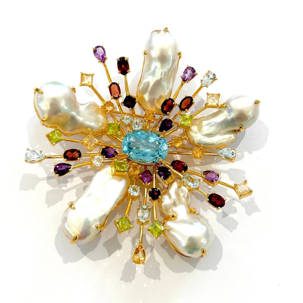 Bochic “Orient” Blue Topaz & Multi Gem Brooch Set In 18K Gold & Silver 

Natural Blue Topaz, Oval shape - 6 carat 
Multi color Natural Gems 
7 carat
White South Sea Pearls 

The Brooch is from the 