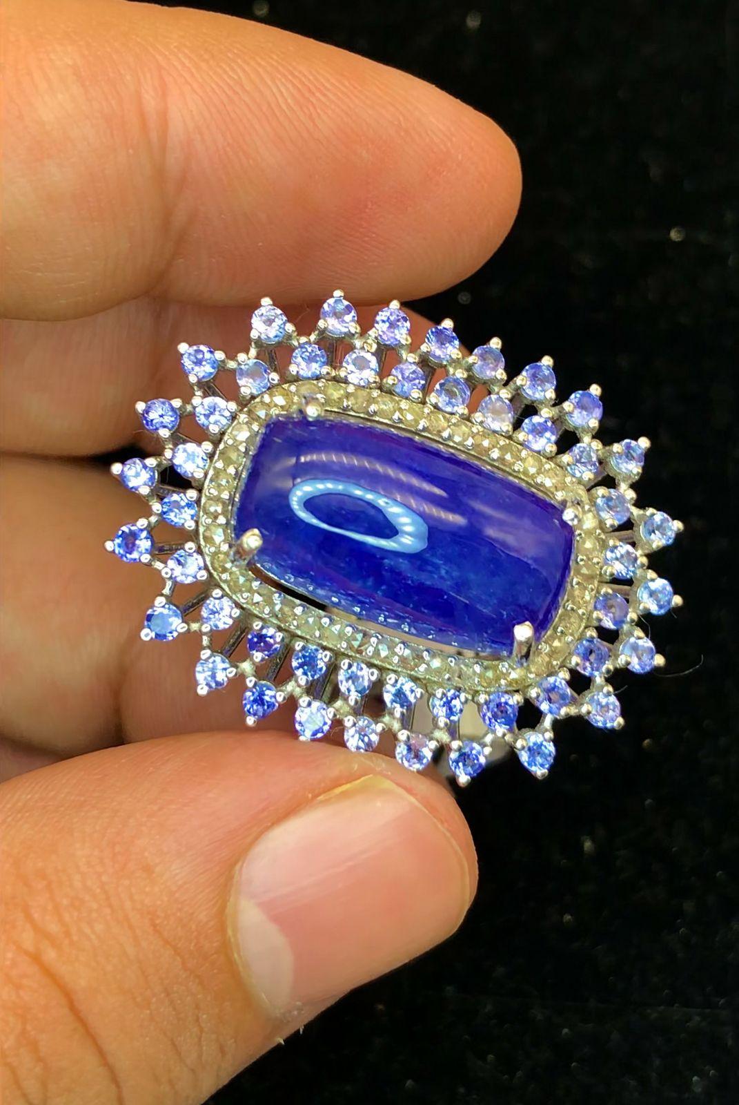 Bochic “Orient” Natural Diamond & Tanzanite Cocktail Ring Set In 18K Gold & Silver 

Natural Cabochon Tanzanite 17.50 Carat 
Natural Round Brilliant Cut Fancy Yellow Diamonds 
1.00 Carat
Natural Round Brilliant Tanzanite - 2.00 Carat 

This Ring is