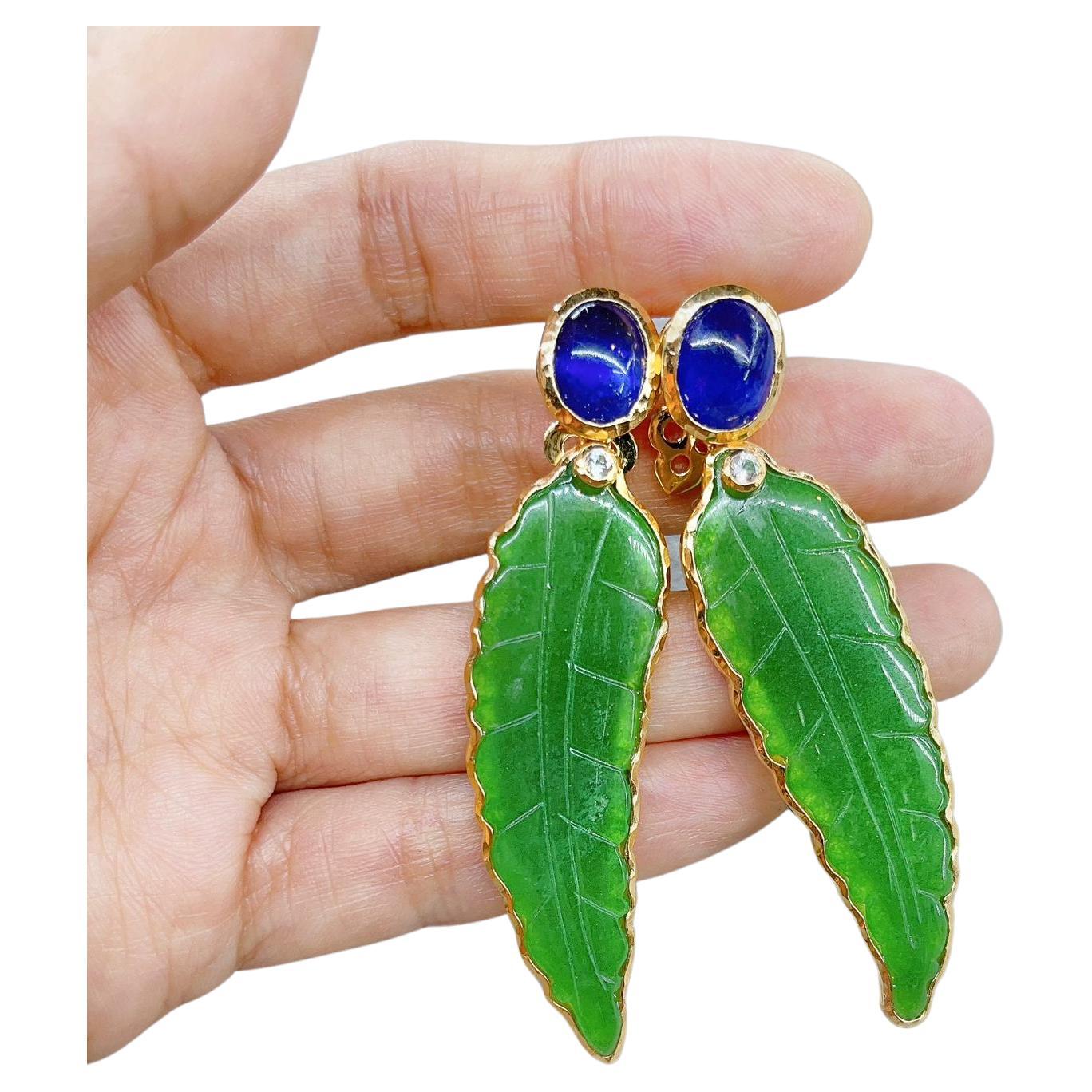 Bochic “Orient” Multi Gem Earrings 
Natural Sapphire, Colors - Blue - 7 Carats 
Shape - Cabochon
Natural White Topaz - 0.25 Carats 
Shape round brilliant 
Carved Green Jade 
Set in 22K Gold and Silver  
Posts and clip ons 
The Earrings are one of a