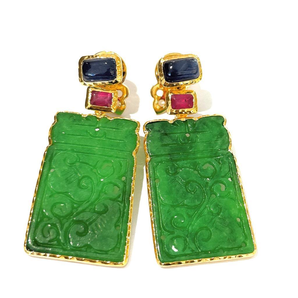Bochic “Orient” Jade, Ruby & Multi Sapphire Earrings Set In 18K Gold & Silver 

Red Ruby Oval Cut Shapes - 2 Carat 
Multi Color Sapphires from Sri Lanka - 7 Carat 
Green carved jade 

The earrings from the 