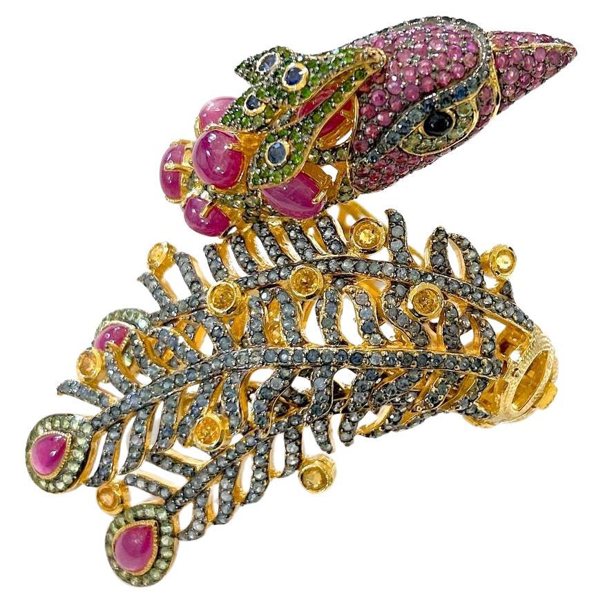Bochic “Orient” Jungle Ruby, Sapphire & Multi Gem Cuff Set In 18K Gold & Silver 

Natural Red Rubies - 16 carat 
Natural Blue, Yellow Sapphires and Green Tsavorite 
10 carat 

This Cuff is from the 