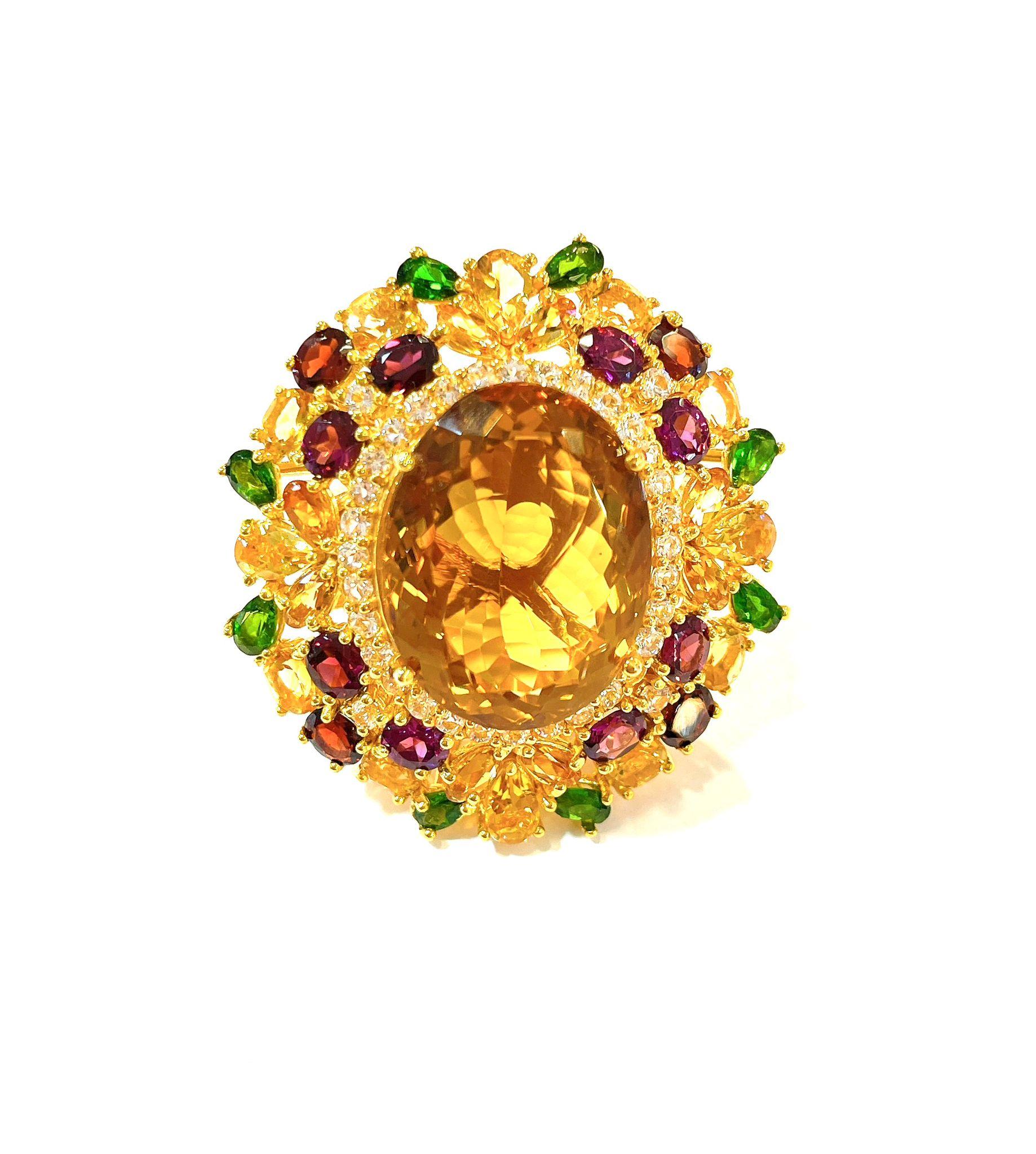 Bochic “Orient” Lemon Citrine & Multi Gem Cocktail Ring In 18K Gold & Silver 

Natural Lemon Citrine Oval cut  
7 Carat 
Natural Tsavorite  
Natural Amethyst 
Natural White Topaz 
4.50 Carat 

This Ring is from the 
