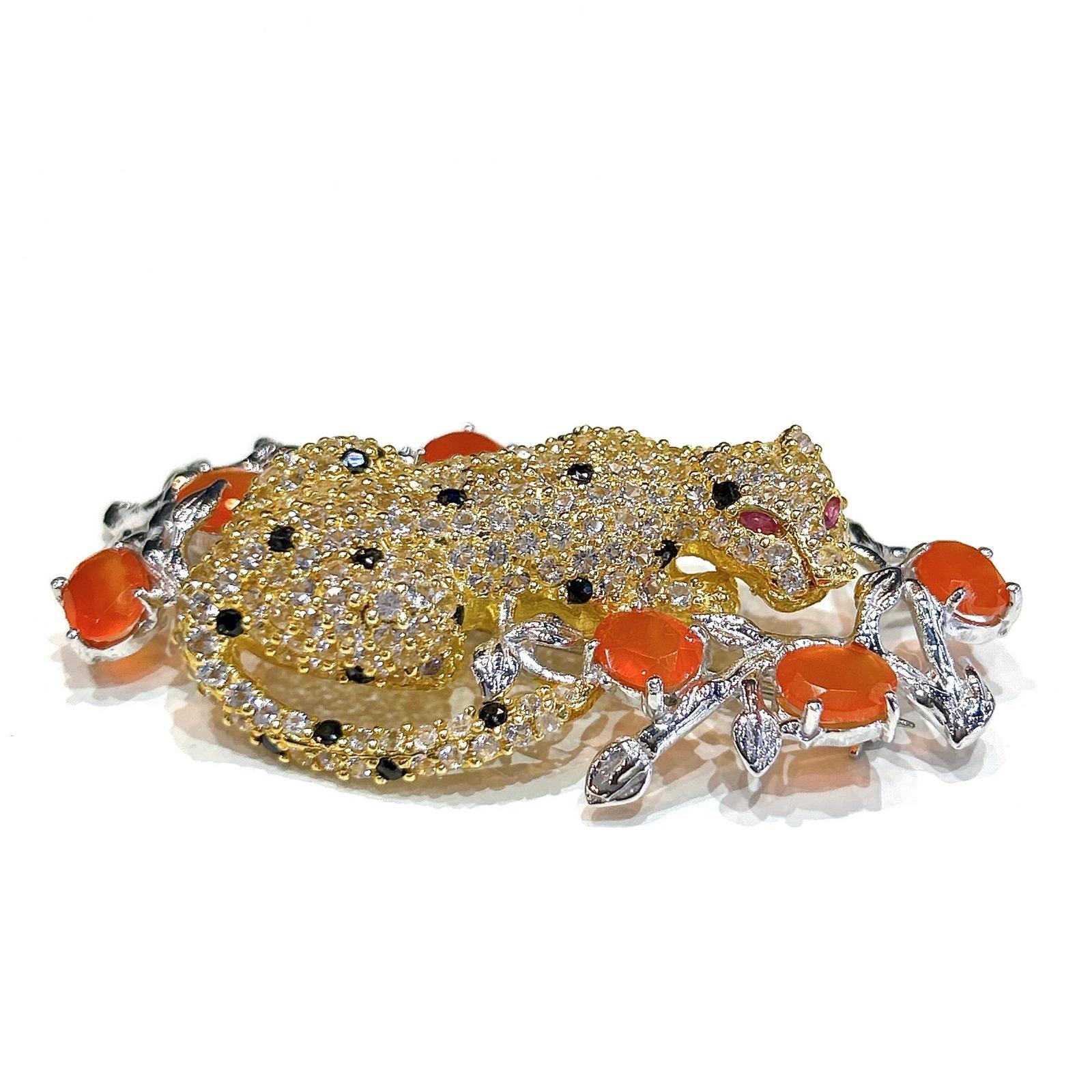 Bochic  “Orient” Mandarin Garant & Sapphire Brooch Set In 18K Gold & Silver

Natural Mandarin Garnet - 13 carat
Natural Sapphires from Sri Lanka - 3 carat
Natural White Topaz - - 4 carat

Can be worn as a pendent as well. 

The Brooch is from the