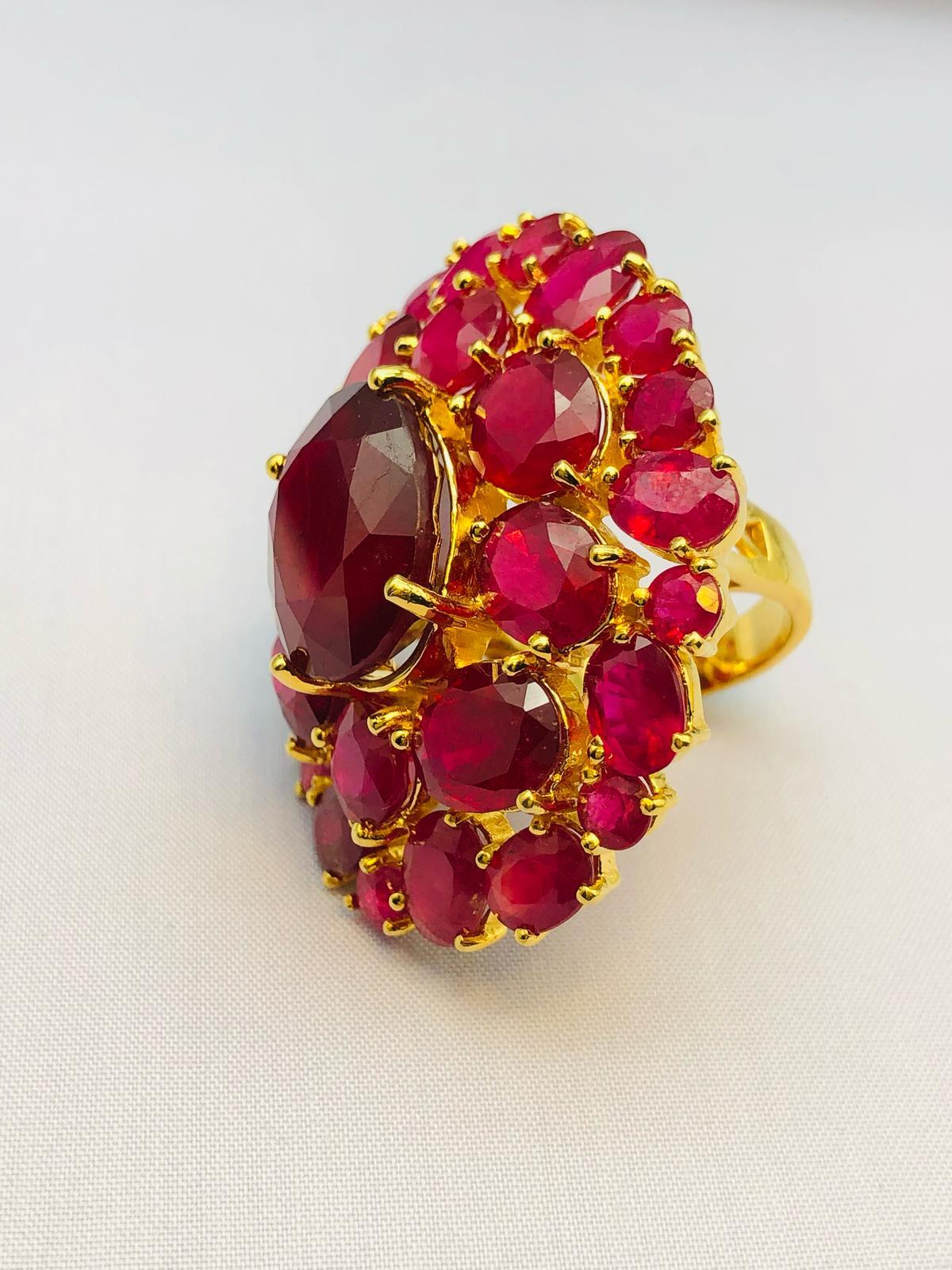Bochic “Orient” Natural Ruby Cocktail Ring Set In 18K Gold & Silver with Certificate

Natural Center Ruby - 8.00 Carat 
Natural Round Brilliant Rubies Cluster - 30.00 Carat 

This Ring is from the 