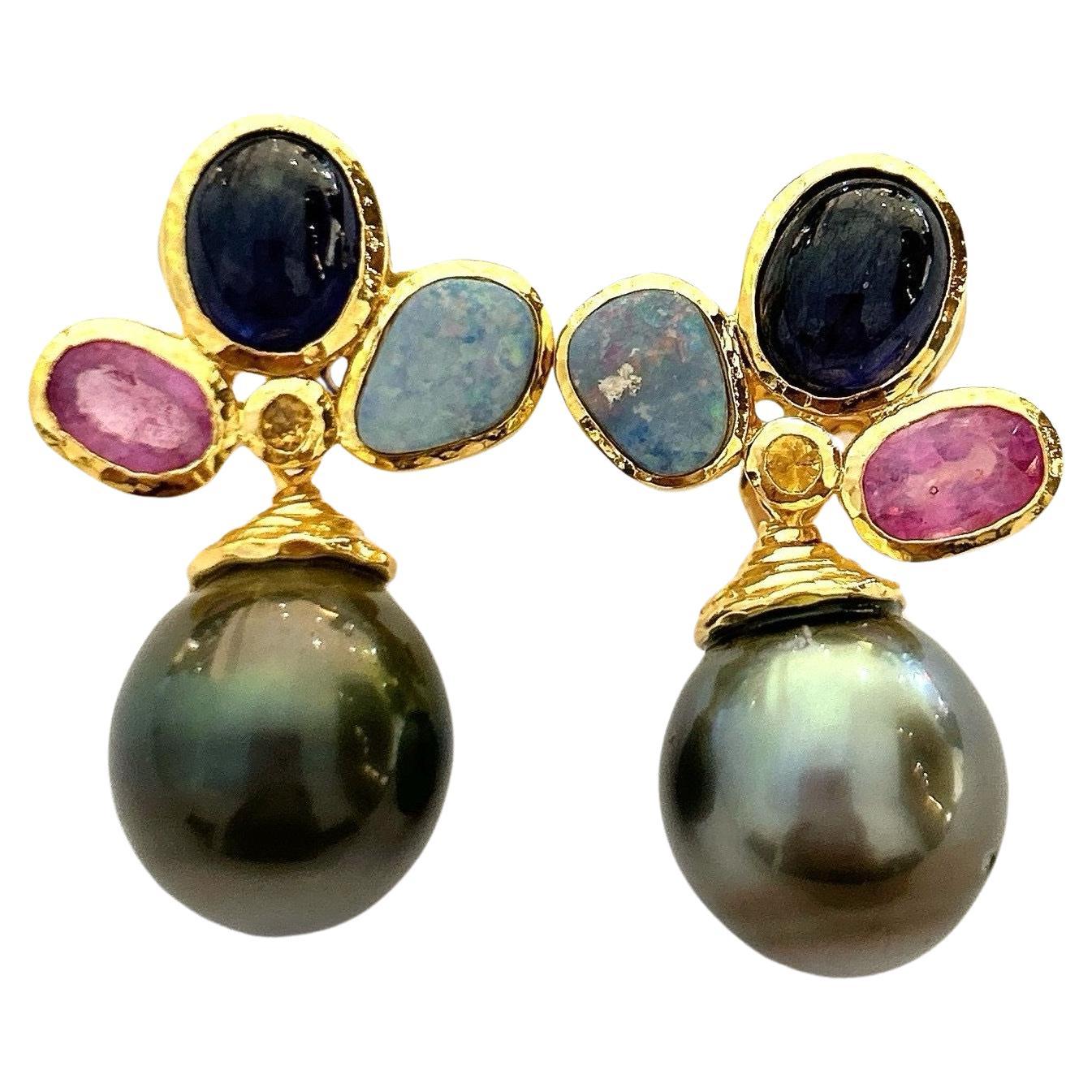 Bochic “Orient” Multi Gem & South Sea Pearl Earrings Set In 18K Gold & Silver 

Natural Blue Opals - 2 Carats
Natural Red Ruby - 3.50 Carats 
Natural Blue Sapphire - 8 Carats 
South Sea Tahiti Pearls, Dark Green and Pink tone 


The earrings from