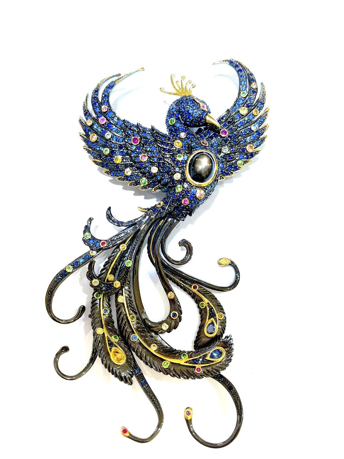 Bochic “Orient” Multi Sapphires & Black Star Brooch Set In 18K Gold & Silver 

Natural Black Star Sapphire  Oval shape - 5 carat 
Multi color Natural Sapphires from Sri Lanka 
5 carat 
Natural Blue sapphire from Sri Lanka 
54 carats 

The Brooch is