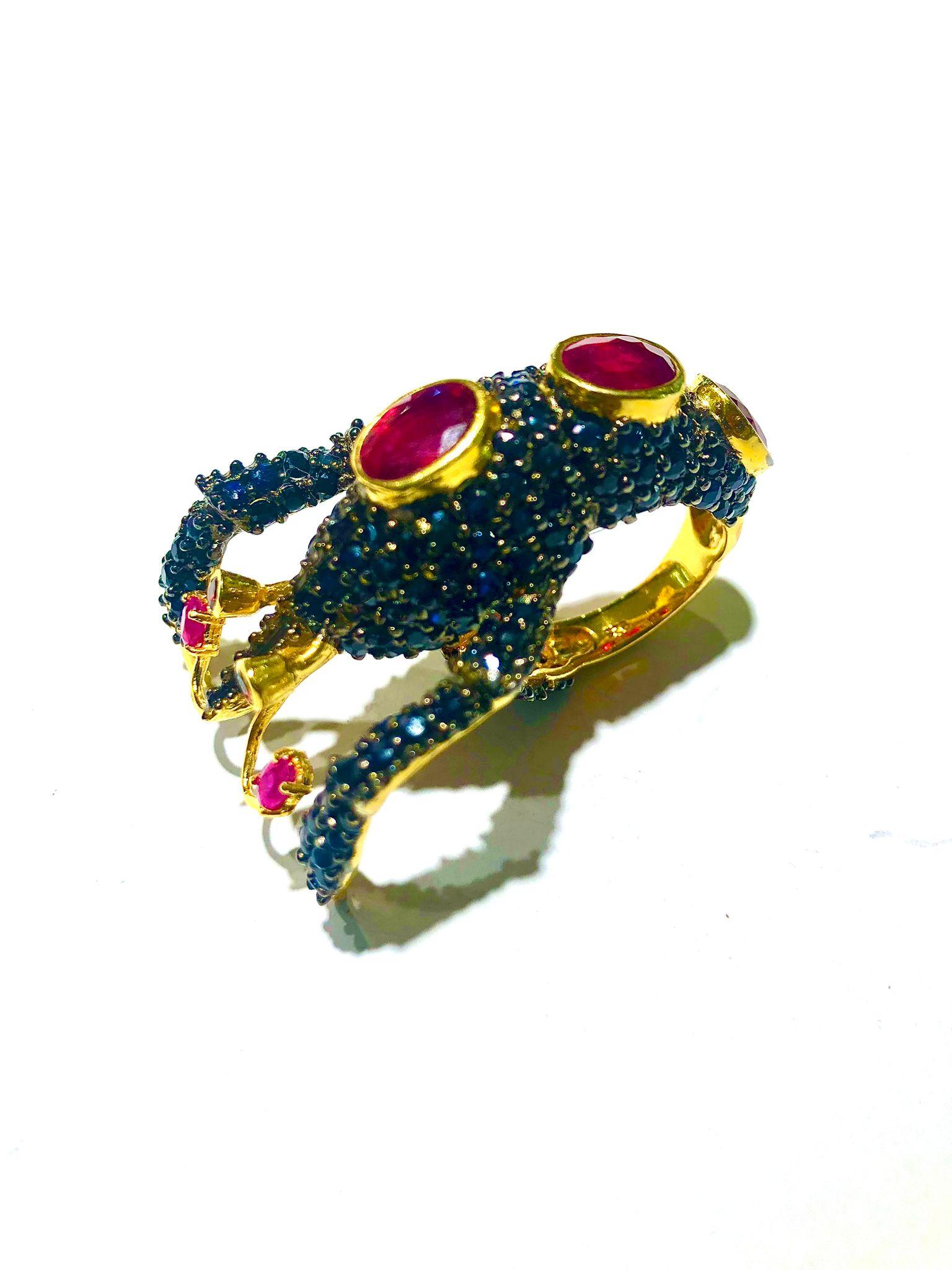 Bochic “Orient” Natural Blue Sapphire & Natural Ruby Ring Set In 18K Gold&Silver

Natural Center Ruby
9.00 Carat 
Natural Round Brilliant Multi Blue Sapphires
6.00 Carat 

This Ring is from the 