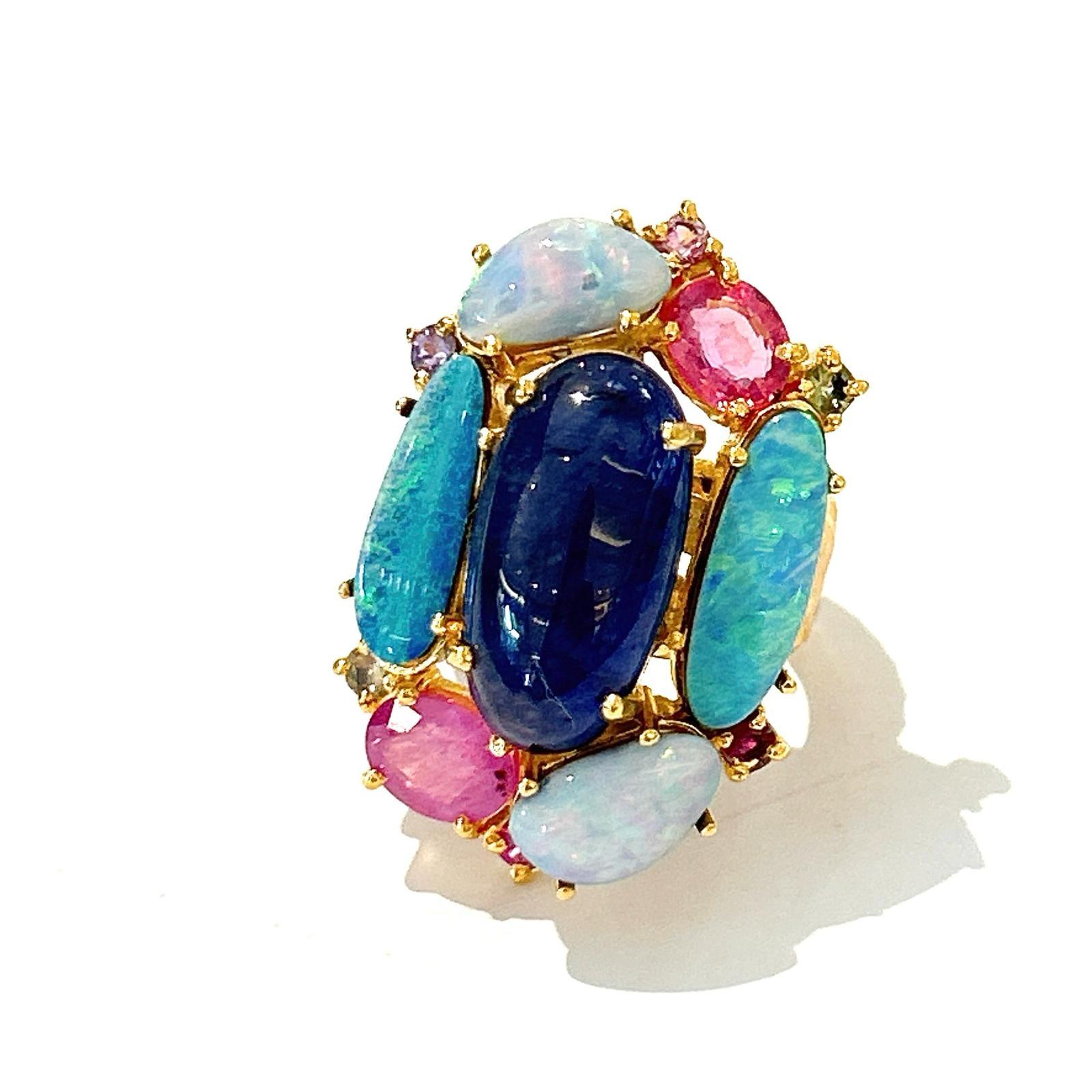 Bochic “Orient” Opal, Ruby & Multi Sapphire Vintage Cluster Ring Set 18K & Silver 

Center Blue Sapphire  - 5  Carat 
Ruby natural - 4 Carats 
Orange natural sapphire 
Blue round brilliant sapphire 
Pink sapphire 
1 carat 

This Ring is from the