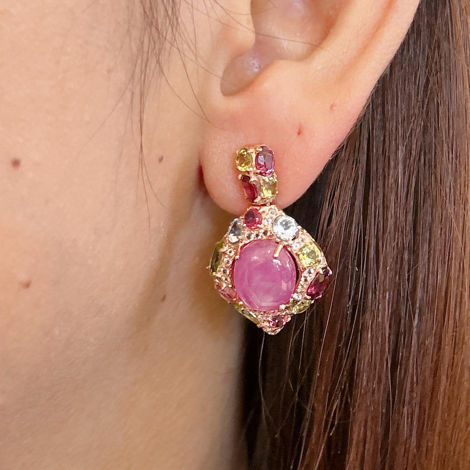 Bochic “Orient” Pink Ruby & Blue Topaz  Earrings Set In 18K Gold & Silver 

Natural Pink Ruby  - 6 carat  
Natural Blue Topaz  - 4.40 carat 
Natural Green Peridot - 4 carat 
Natural Amethyst - 4 carat 

The earrings from the 