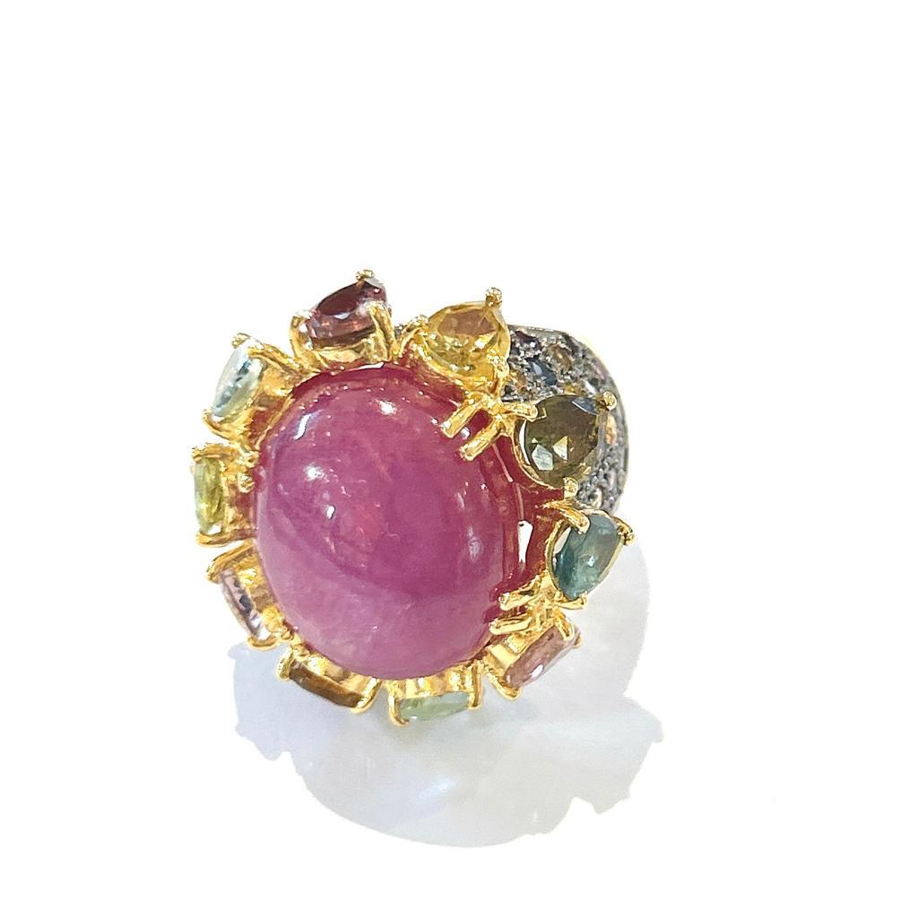 Bochic “Orient” Red Ruby & Multi Color Sapphires Ring Set In 18K Gold & Silver 
Red Natural Ruby Cabochon - 12 Carat 
Multi color natural sapphires and Mix Gems 
2 carats 

This Ring is from the 