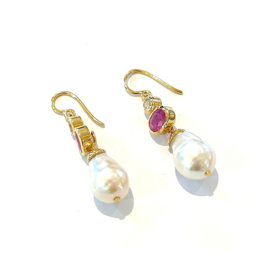 Bochic “Orient” Red Ruby & South Sea Pearl Earrings Set In 18K Gold & Silver

Red Ruby Oval Shape  - 4 Carats 
White south sea Barque Pearls 
White Topaz - 1.40 Carats 

The earrings from the 