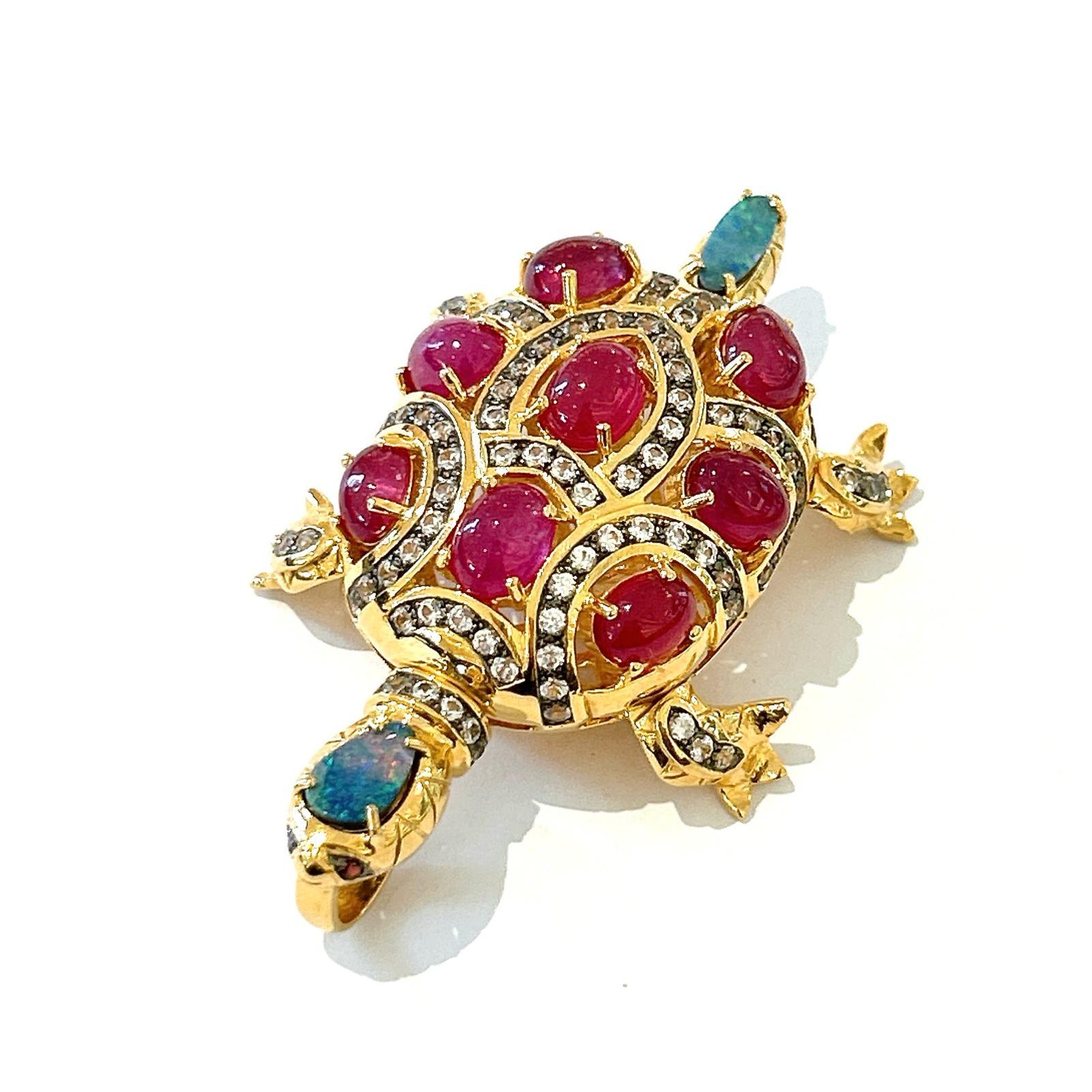 Bochic “Orient” Retro Multi Ruby, Topaz & Opal Brooch Set In 18K Gold & Silver 

Can be worn as a brooch and a pendant 

Red color Natural Ruby From Africa 
17 carat
Multi color Natural Opals
2 carat 
White Topaz 
3 carat 


The Brooch is from the
