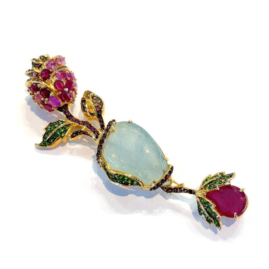 Bochic “Orient” Ruby, Aquamarine & Garnet Brooch Set In 18K Gold & Silver 
Natural light blue aquamarine - 24 Carats 
Pear Shaped red ruby - 6 Carats 
Natural Garnets, Tsavorite and Muti color sapphires - 6 Carats 

This Brooch is one of a kind from