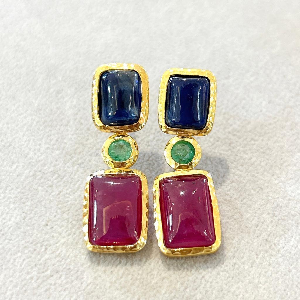 Bochic “Orient” Ruby, Emerald & Sapphire Earrings Set In 18K Gold & Silver 

Natural Ruby Cabochons From Burma - 10 Carat
Natural Sapphire Cabochons From Sri Lanka - 7 Carat 
Natural Emerald Round Brilliant From Zambia - 1 Carat 

3 Gem Luck