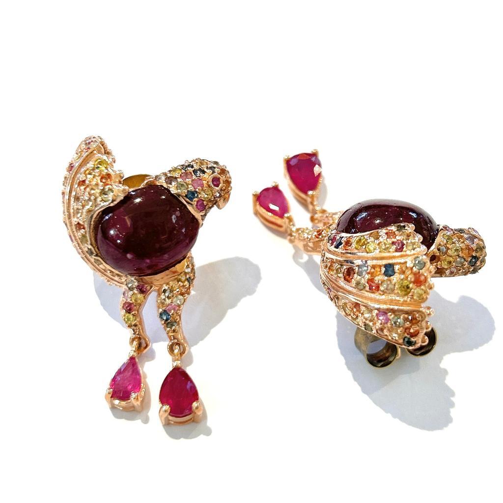Bochic “Orient” Ruby & Fancy Color Sapphires Set In 18K Gold & Silver Earrings

Natural Red Rubies Cabochons and Pear Shapes 
15 carats 
Natural Fancy color Multi Sapphires from Sri Lanka 
4 carats 

The earrings from the 