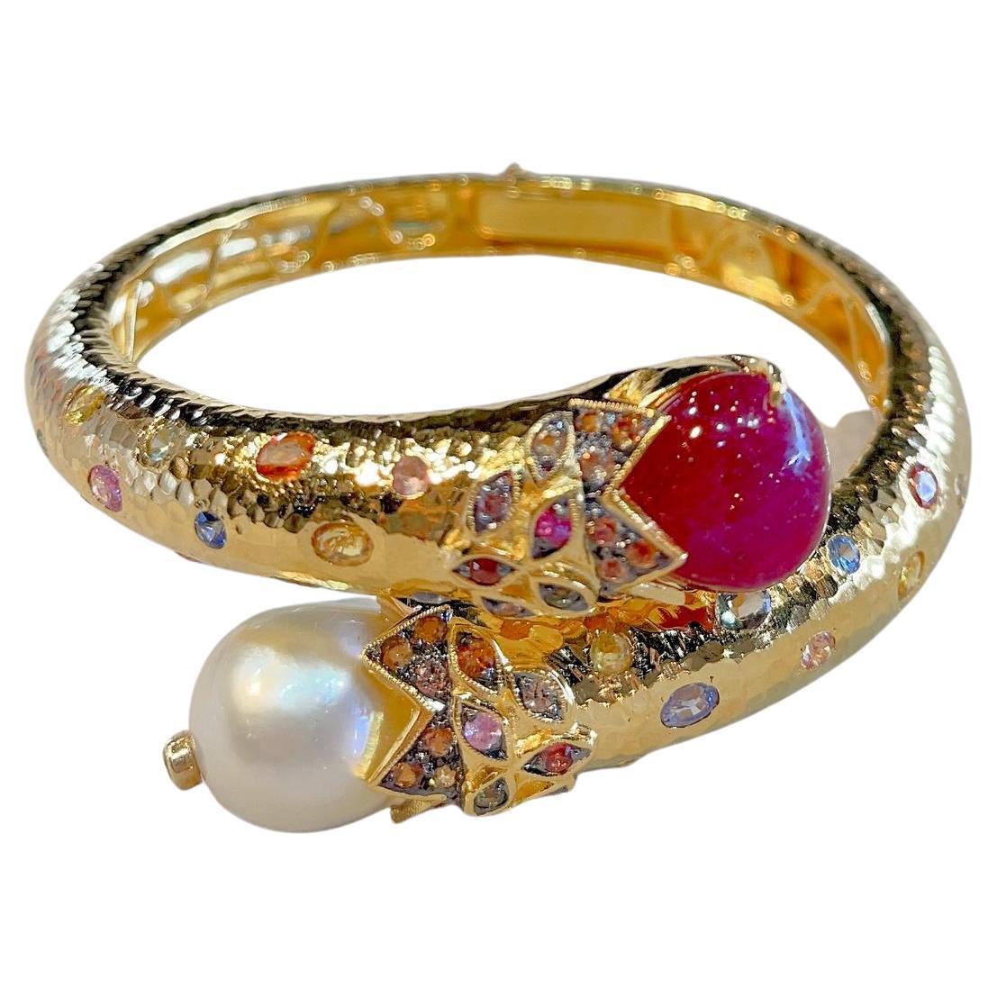 Bochic “Orient” Bangle, Ruby 
Fancy Sapphire & South Sea Pearl set in 22 Gold & Silver 
Natural Red Cabochon - 14 carats in total
Baroque white south sea natural cultured pearls
White color, with pink and silver tones 
Fancy color sapphires 6.6