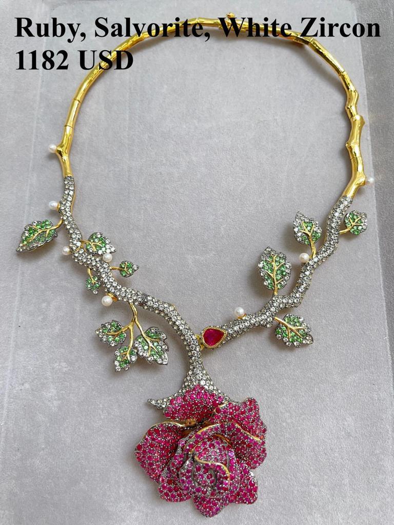 Bochic “Orient” Ruby & Multi Gem Flower Necklace Set In 18K Gold & Silver 

Natural Red Ruby - 6 carat 
Multi color Natural Sapphires, Garnets, Topaz 
13 carat
White South Sea Pearls 

The Necklace is from the 