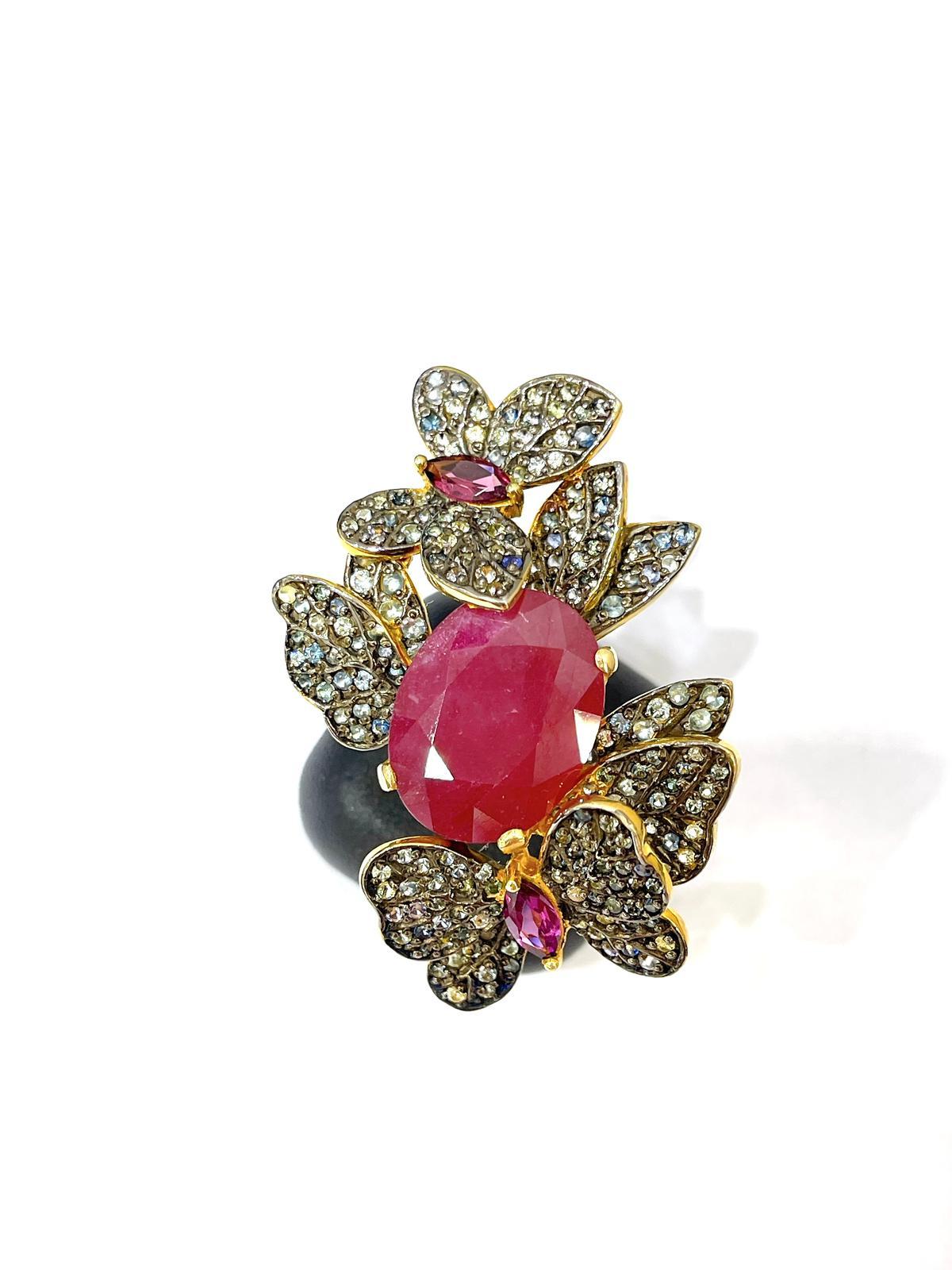 Bochic “Orient” Ruby & Multi Sapphire Vintage Cluster Ring Set 18K & Silver 

Red natural ruby, Oval cabochon shape - 6 carats 
Yellow natural sapphire 
Orange natural sapphire 
Pink natural sapphire 
Yellow natural sapphire 
Green natural Emerald