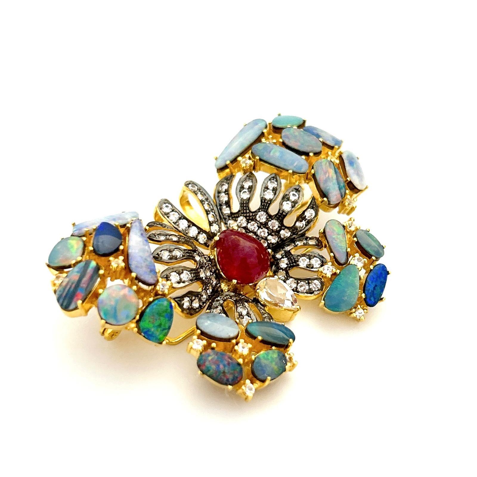 Bochic “Orient” Ruby, Opal & White Topaz Brooch Set In 18K Gold & Silver 
Can be worn as a brooch and a pendant 

Natural Red Ruby  - 5 carat 
Multi color Natural Opals
6 carat
Natural White Topaz  - 2 carat

The Brooch is from the 