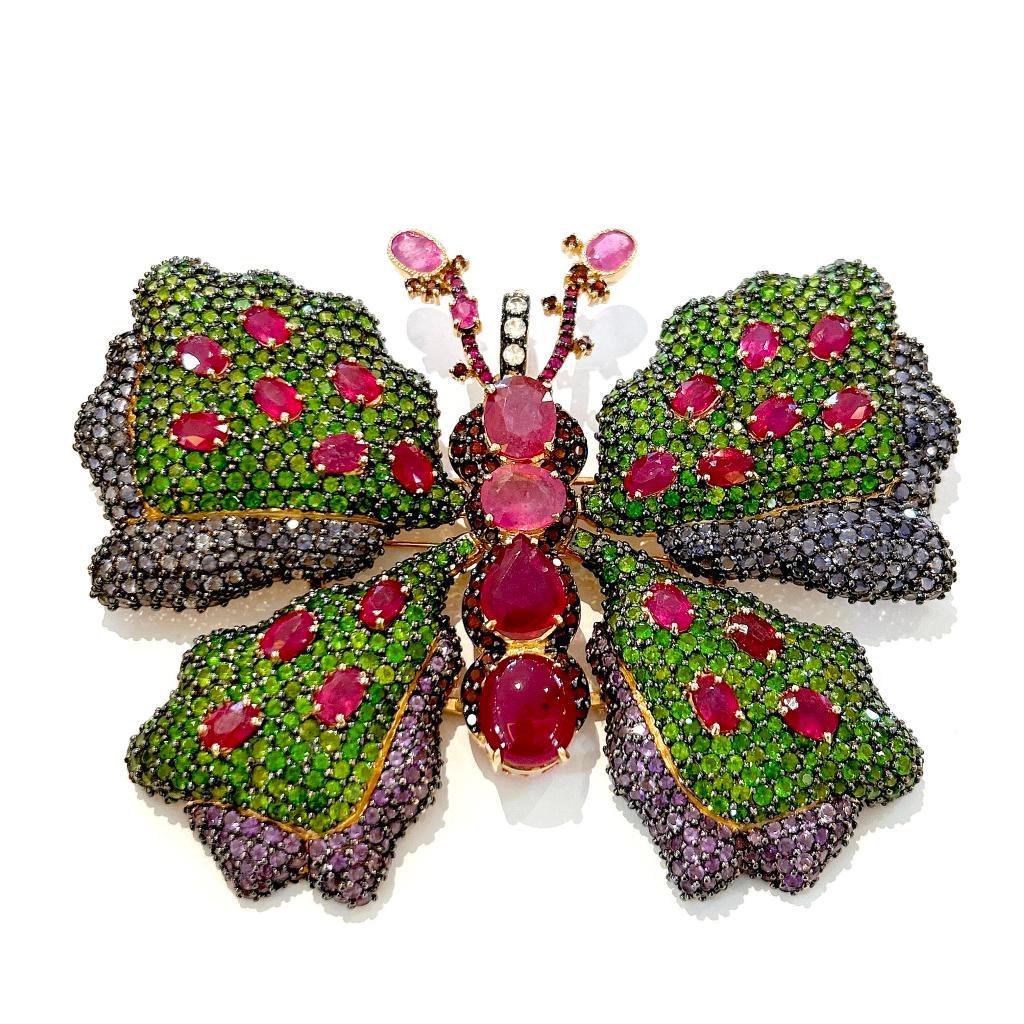 Bochic “Orient” Ruby & Multi Gem Brooch Set In 18K Gold & Silver 

Natural Red Ruby, Oval shape, Cabochon, Pear Shape  16 carat 
Pink color Natural Sapphires from Sri Lanka 
2 carat
Green color Natural Tsavorite 
4 carat 

The Brooch is from the