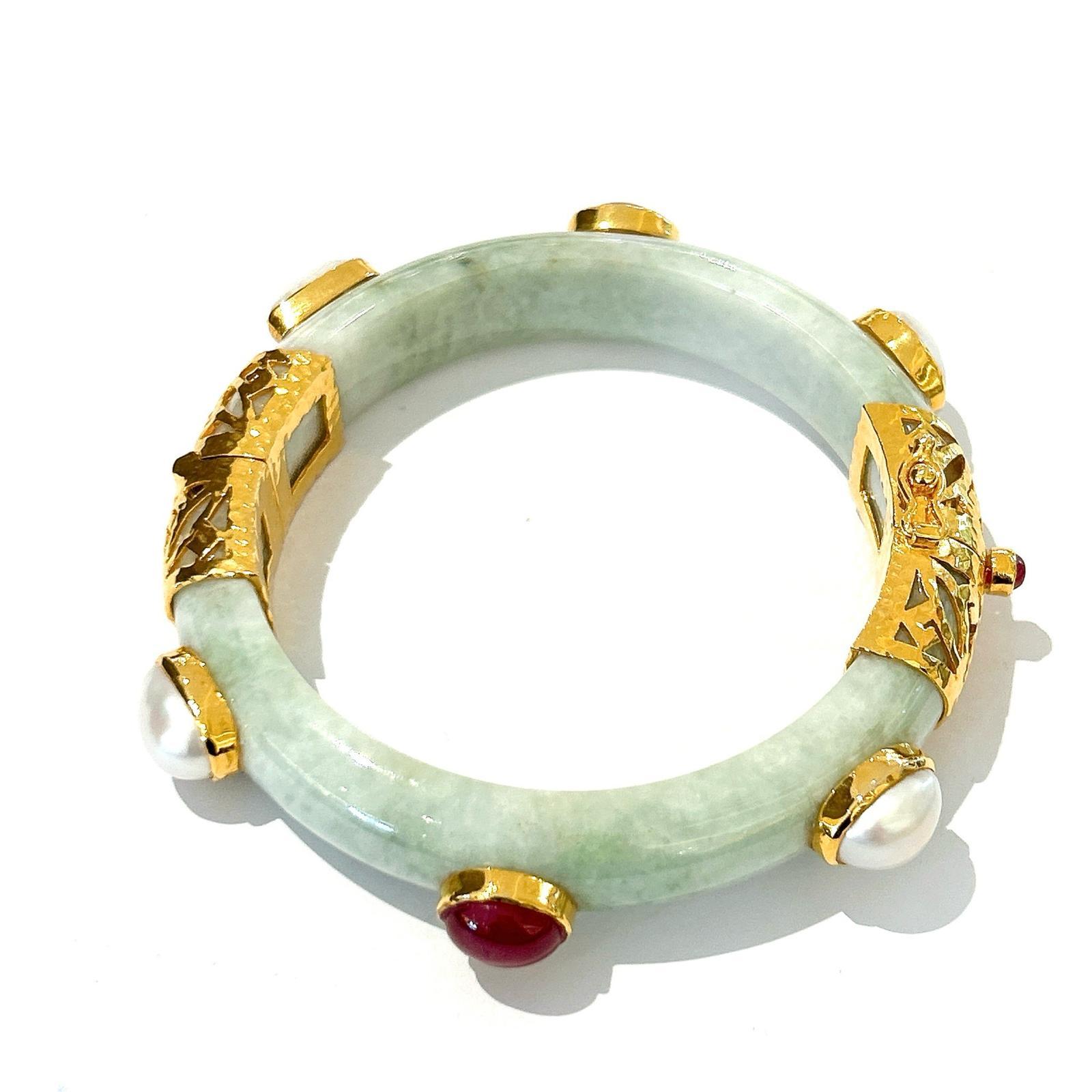 Bochic “Orient” Ruby & Sapphire Vintage Jade Bangle Set In 18K Gold & Silver 

Natural red rubies - 4 Carats 
Natural Blue sapphires - 4 Carats
Vintage Mint Green Jade 

The bangle has an open and close hinge 

This bangle is from the 