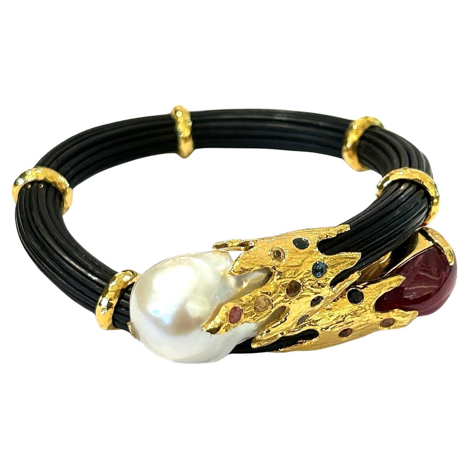 Bochic “Orient”  Ruby, Sapphires & Pearl Bangle Set In 18 K Gold & Silver 

Natural Cabochon Ruby - 6 carats 
South sea white pearl 
Multi color sapphires - 0.50 carats 


This Bangle is from the 