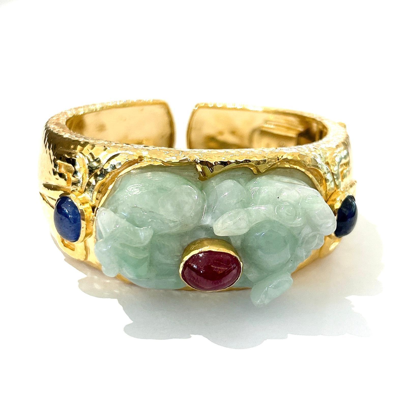 Bochic “Orient”  Ruby, Sapphires & Mint Jade Vintage Cuff Set In 18 K Gold & Silver 

Natural Cabochon Ruby - 6 carats 
Blue color sapphires - 5.00 carats 
Vintage Jade from China 
Mint green 
Rabbit shape carving for good luck

This Bangle is from