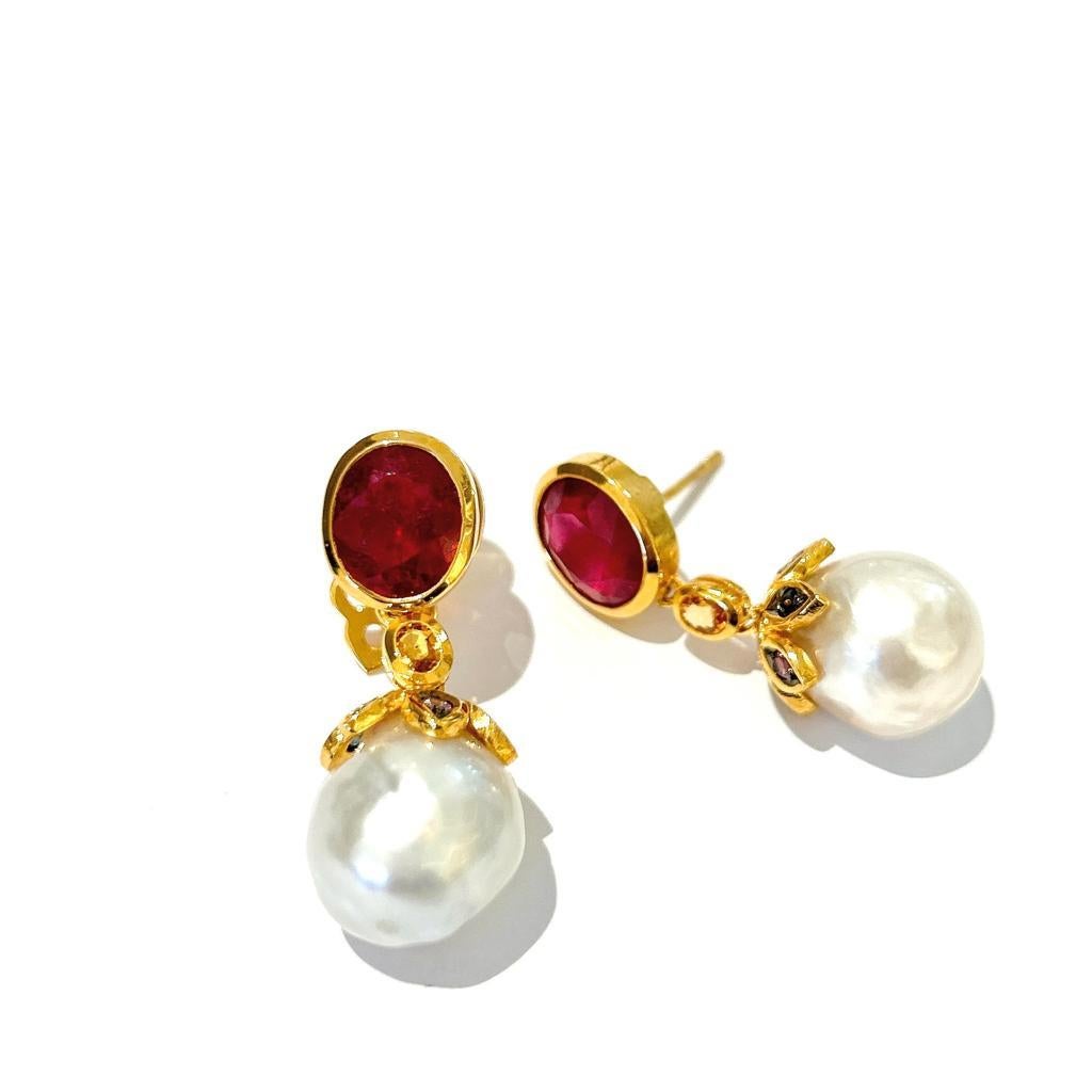 Bochic “Orient” Ruby & South Sea Pearl Earrings Set In 18K Gold & Silver 

Natural Oval Shapes Rubies 
6 carats 
Multi Color Sapphires from Sri Lanka 
0.55 carats 
South Sea Baroque Peals White Color with pinkish silverish tone 

The earrings from