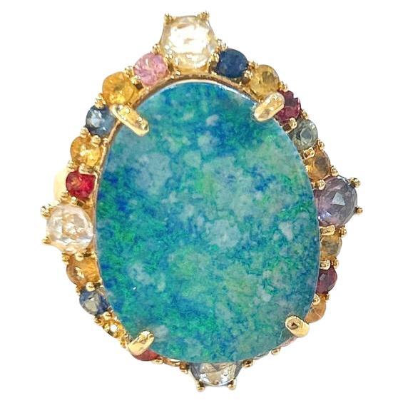Bochic “Orient” Sapphire, Opal & Ruby Cocktail Ring Set In 18K Gold & Silver 

Natural Blue Opal, Cabochon shape - 12 Carats 
Multi color sapphires from Sri Lanka - 2 Carats 
Natural Red Ruby - 0.60 Carats 
Natural White Topaz - 2 Carats 

This Ring