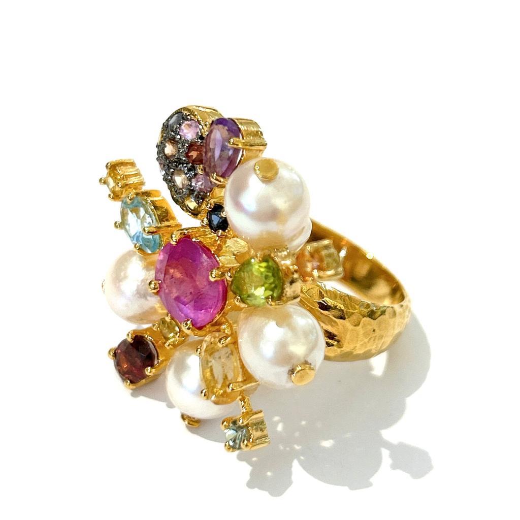 Bochic “Orient” Spark Ruby, Pearl & Multi Gem Ring  Set In 18K & Silver 
Center Oval Shape Natural Ruby - 4 Carat 
Baroque South Sea Pearls, White color with Pink tone 
Multi color Natural Sapphires from Sri Lanka 
1 Carat 
Round Brilliant
Colors: