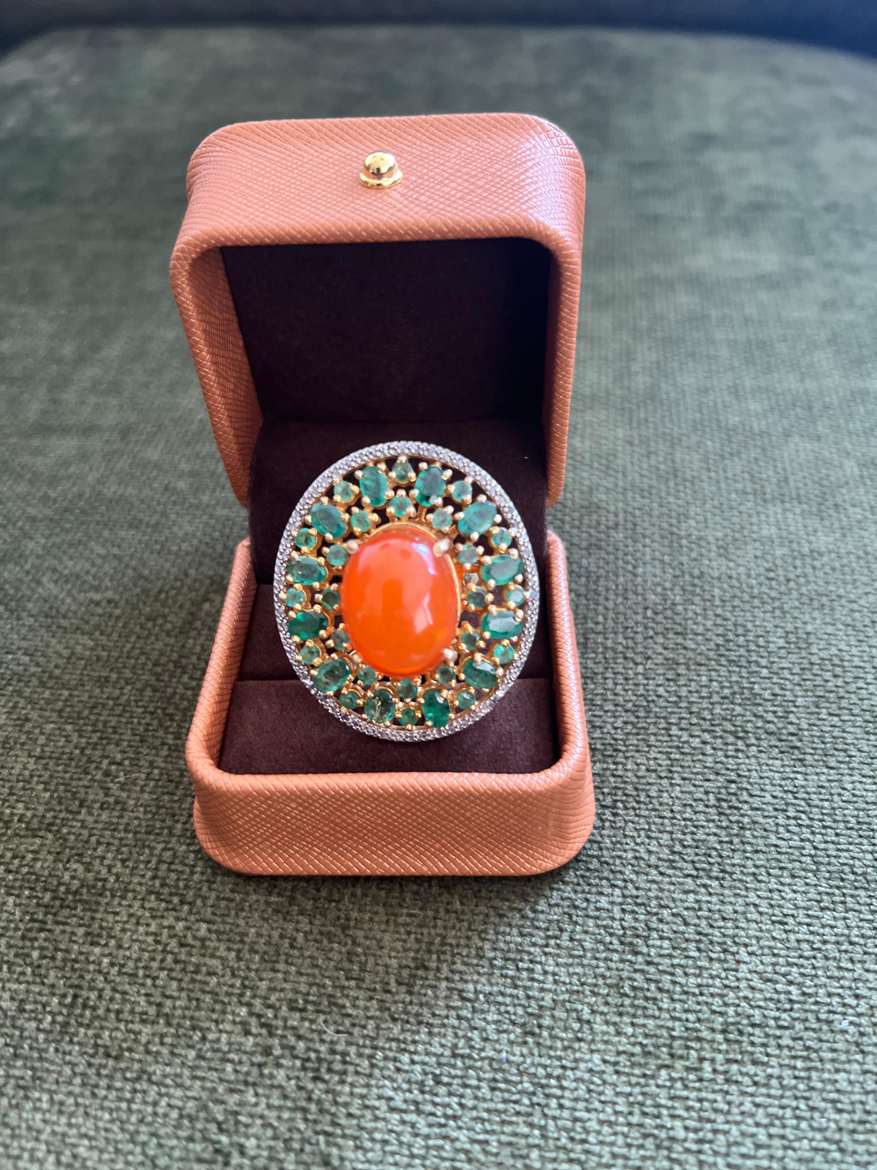 Bochic “Orient” Vintage Diamonds, Emeralds & Orange Opal Ring Set In 18K Gold & Silver 

Natural Center Orange Opal 
9.00 Carat 
Natural Emeralds
3.00 Carats 
Natural Single Cut Diamonds 
1.00 Carats 

This Ring is from the 
