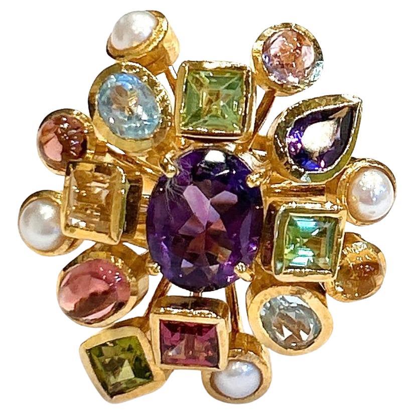 Bochic “Orient” Vintage Retro Multi Gem  Burst Ring Set In 18K Gold & Silver 

Natural Large Oval Amethyst
2 Carats 
Natural Multi Color Gems and Pearls
Blue Topaz, Peridot, Tourmaline, Amethyst, Pink Sapphire, Yellow Sapphire 
4 Carats 

This Ring