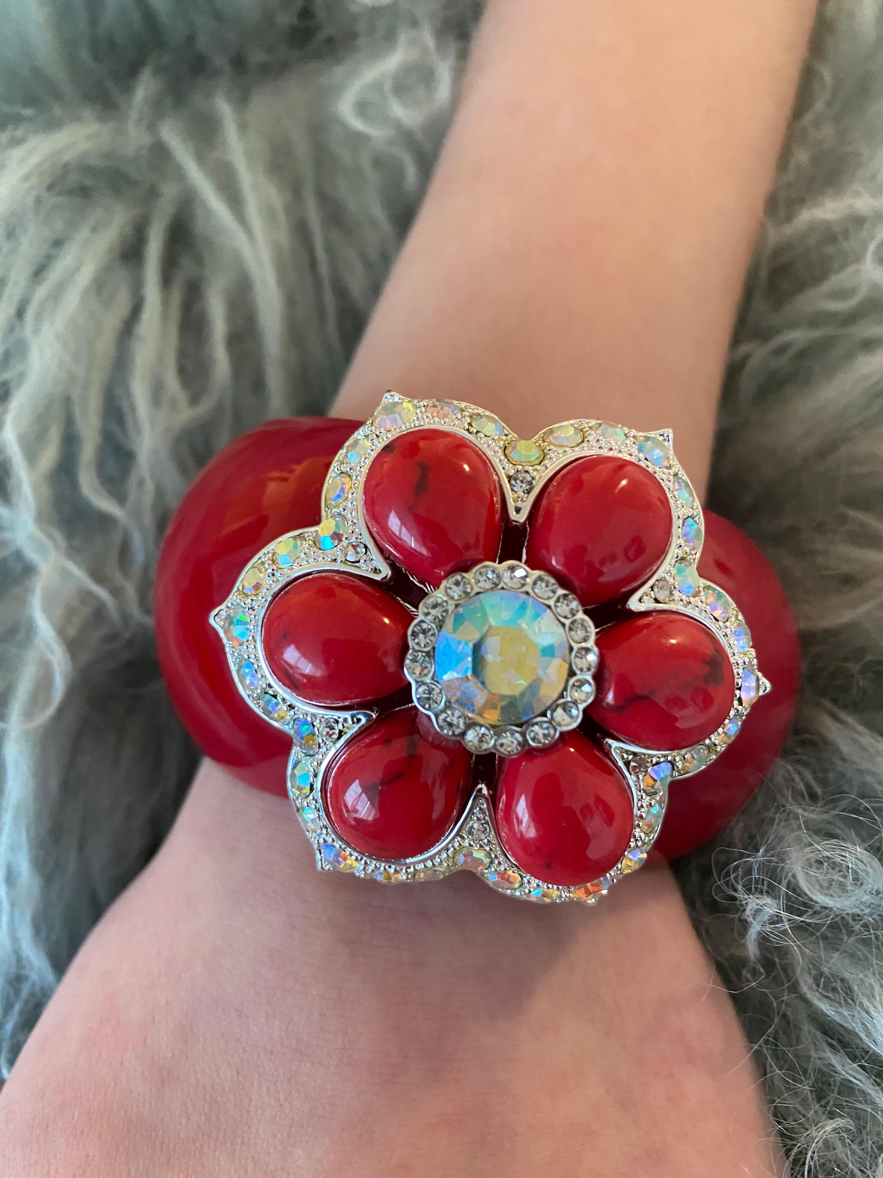 “Volver” Bochic red carpet bijoux jewlery, from the “IKON” private collection. 
 An homage to Pedro Almadovar color motifs. The cuff features a parker rose flower. 
The dangerous red Rasin cuff is set with SWAROVSKI crystals, white plated with an