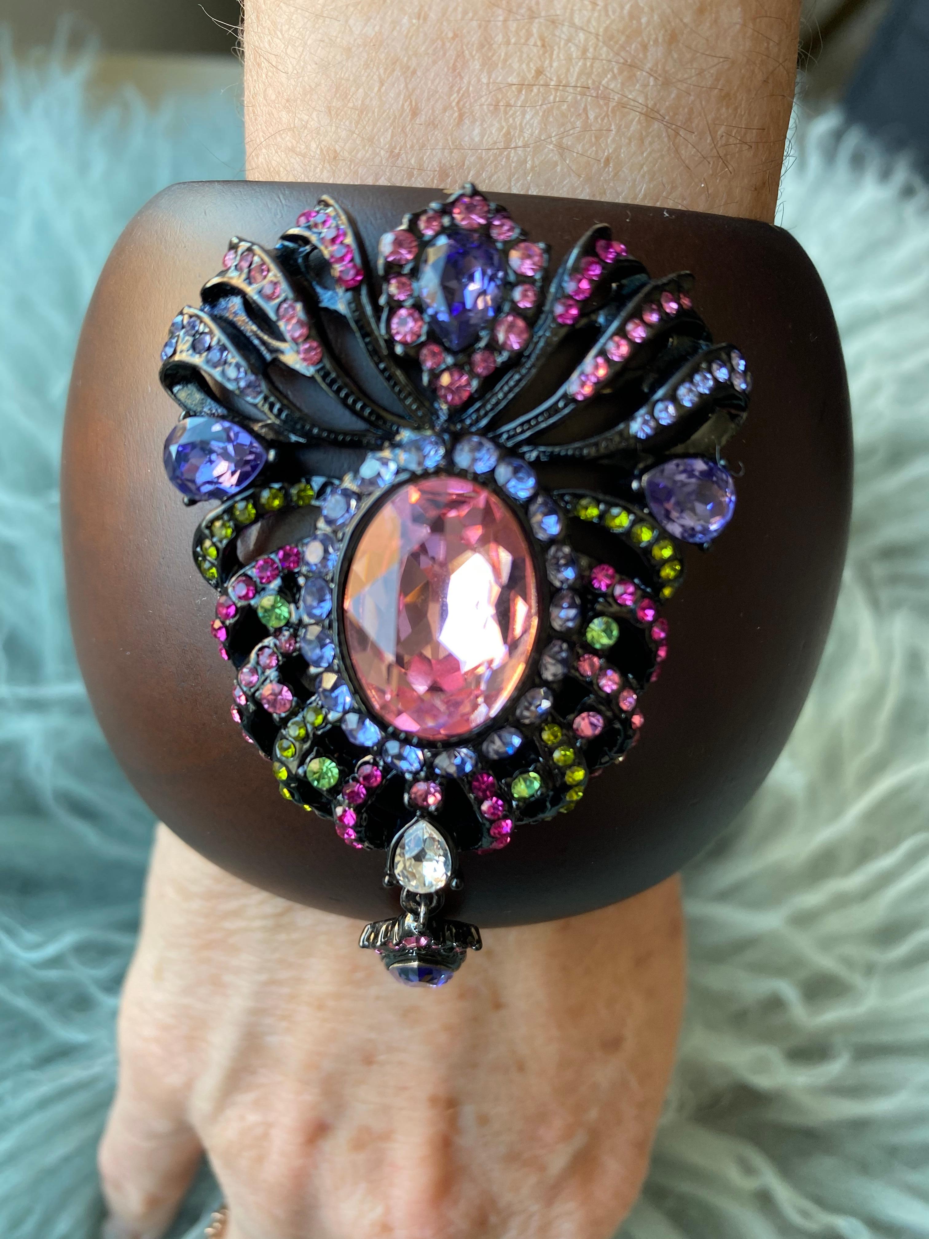 “The Crown Cuff”
Bochic red carpet bijoux jewlery, from the “IKON” private collection. 
The color purple ties the royals to ancient times.
Here we have all the royal colors in one Indian crown motif, rubies red, purples, peridot greens, pinks and a