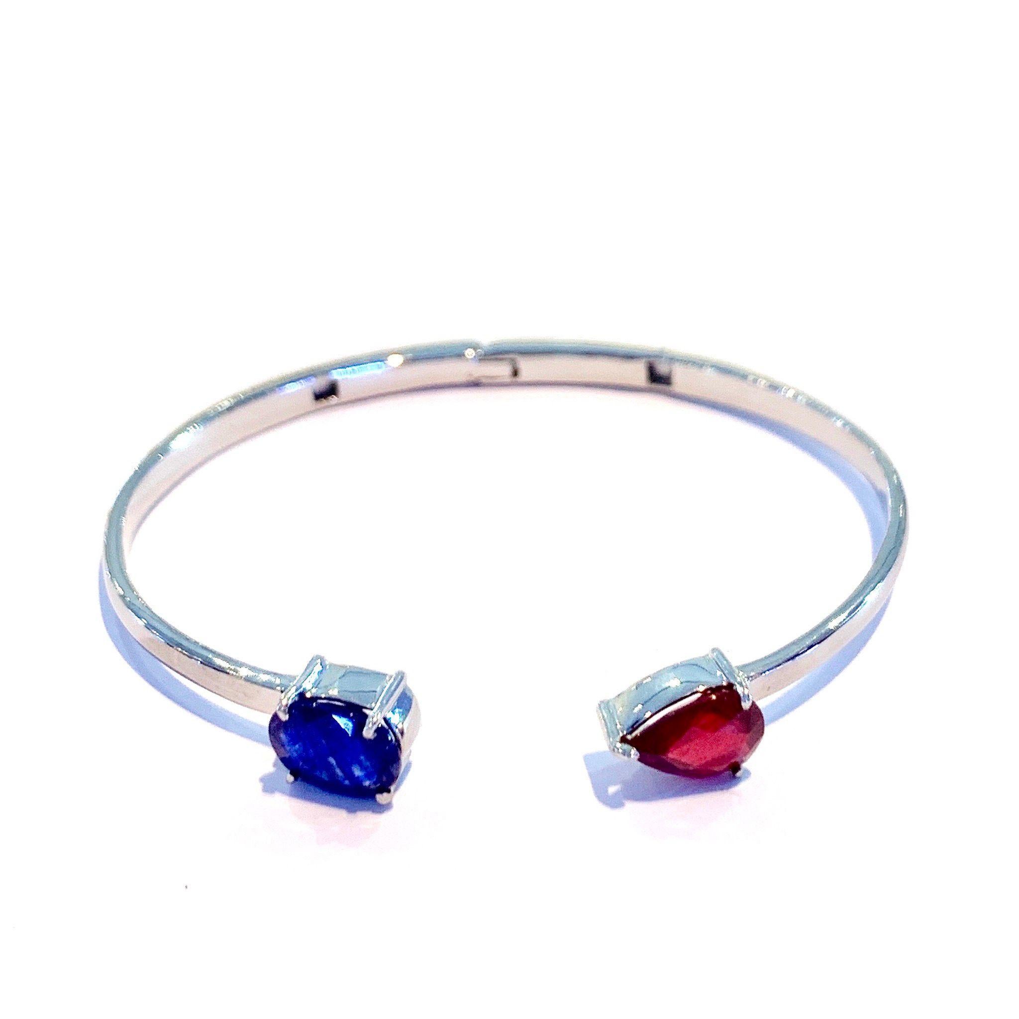 Bochic Silver & White Gold Plating Bangle With Red Ruby and Blue Sapphire 
Natural Blue sapphire 
Sri Lankan 
Oval shape 
4 carats 
Natural Red Ruby 
Pear shape 
3.5 carat 
Silver with 18K White gold plating 
Chic and timeless 
Perfect for stacks