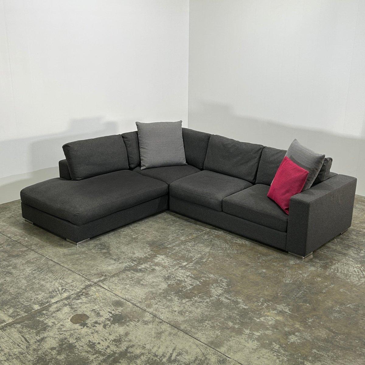 Introducing the BoConcept Grey Corner Sofa, a stunning addition to any modern living space. Crafted with the highest quality materials, this luxurious sofa boasts a sleek and contemporary design, perfect for those seeking both style and comfort. The