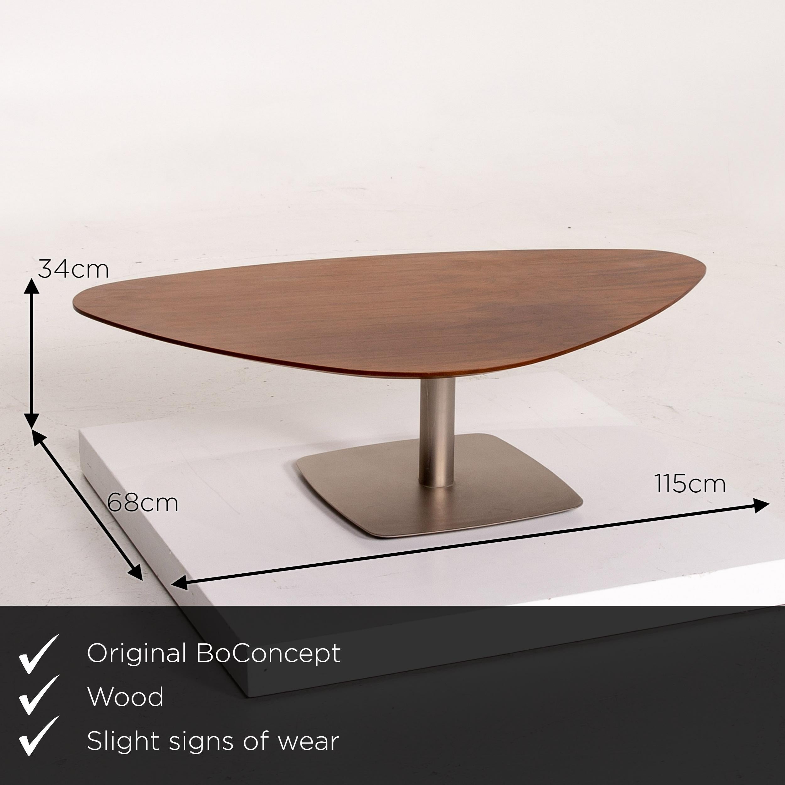 We present to you a BoConcept wooden coffee table brown asymmetrical.
   
 

 Product measurements in centimeters:
 

Depth 68
Width 115
Height 34.




    