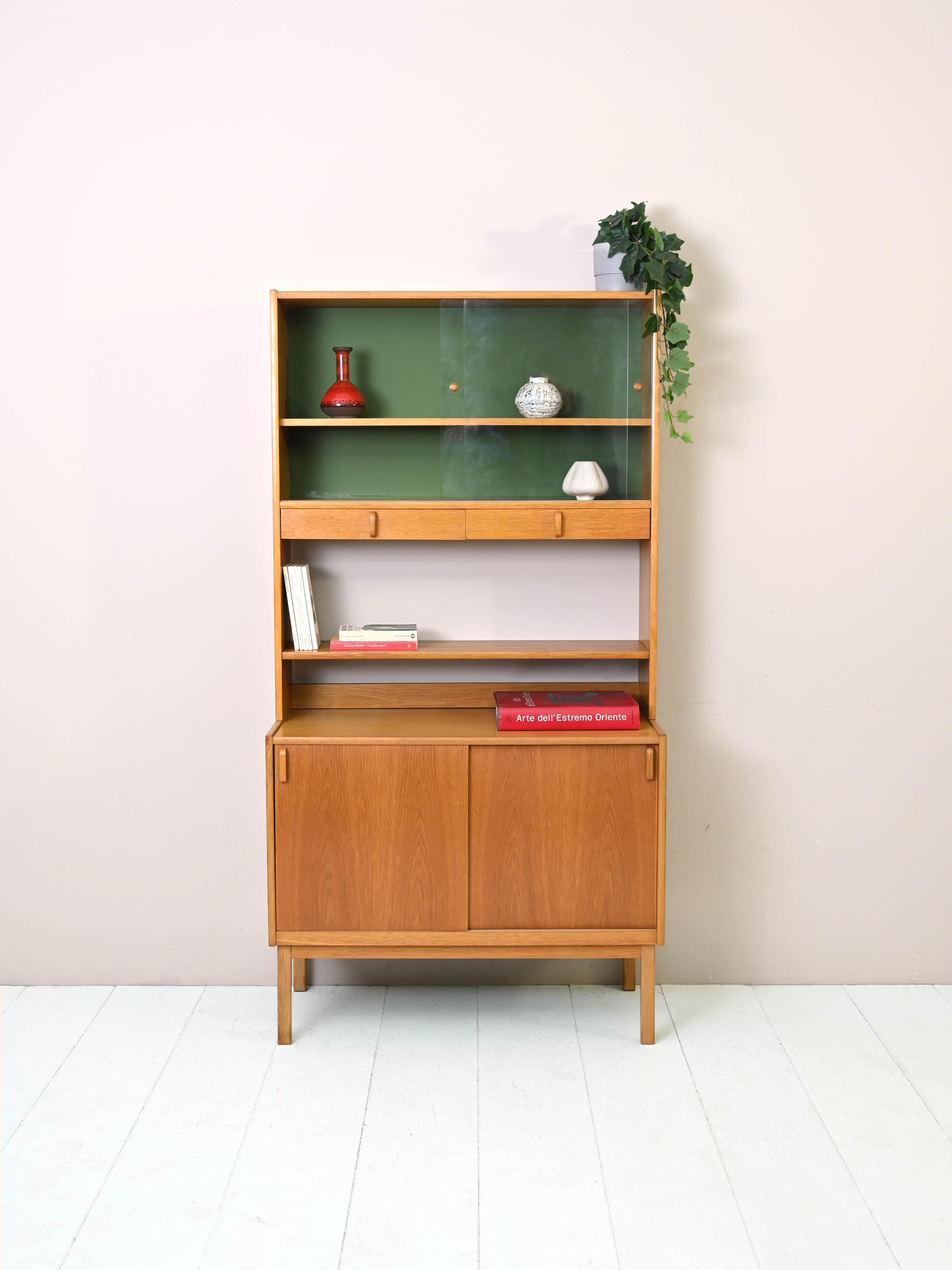 Scandinavian vintage cabinet with hutch.
 
This teak cabinet consists of two parts, the lower part is a small sideboard with sliding doors and the upper part is a shelving unit equipped with shelves, drawers and hutch.
Perfect for use in the