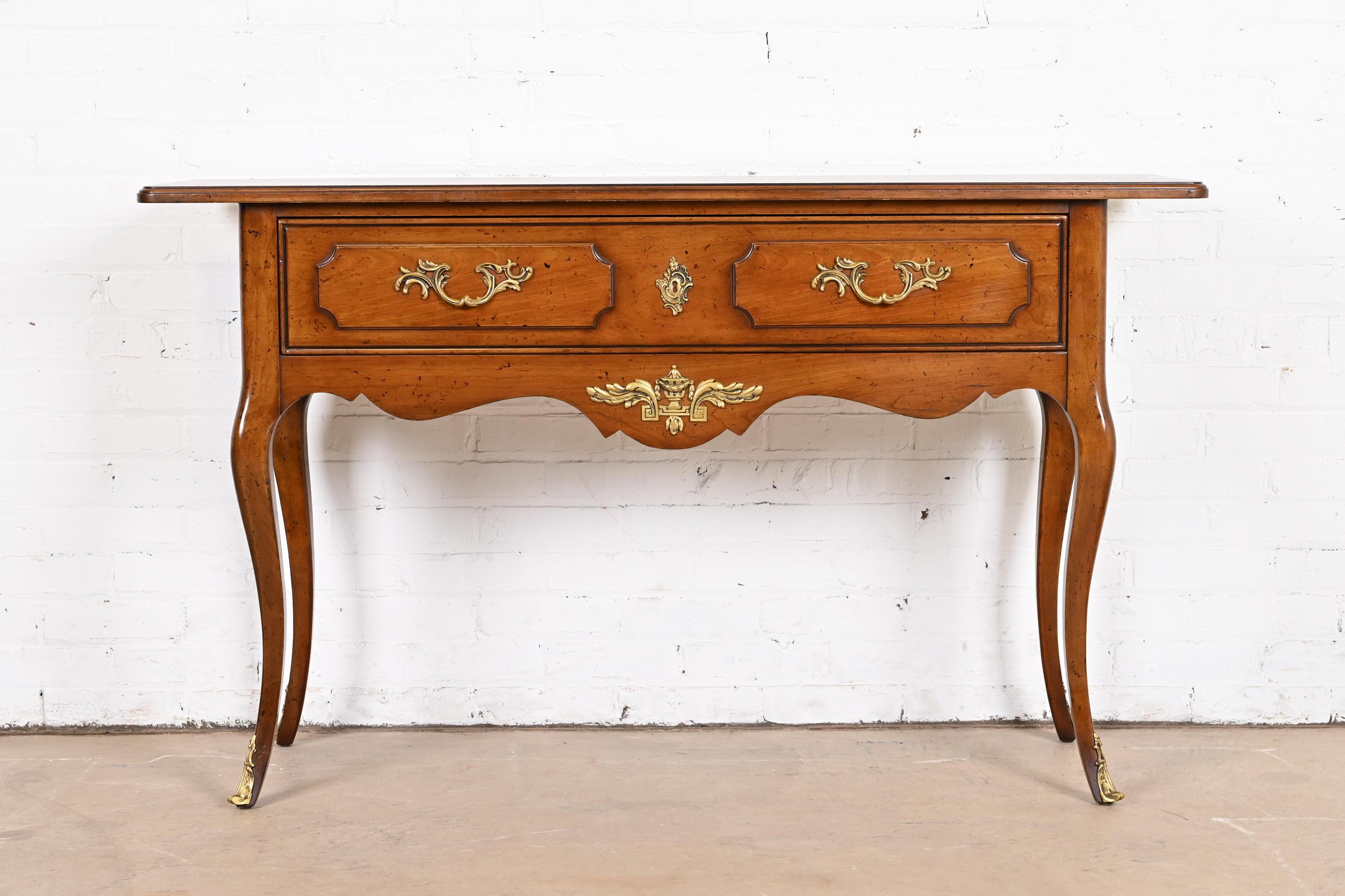 An exceptional French Provincial Louis XV style console table

By Jacques Bodart

USA, Circa 1960s

Carved fruitwood, with original brass ormolu mounts and hardware.

Measures: 54