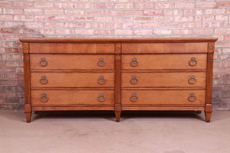 A gorgeous French Regency Louis XVI style eight-drawer dresser or credenza

By Jacques Bodart

USA, circa 1960s

Walnut, with original brass hardware.

Measures: 72