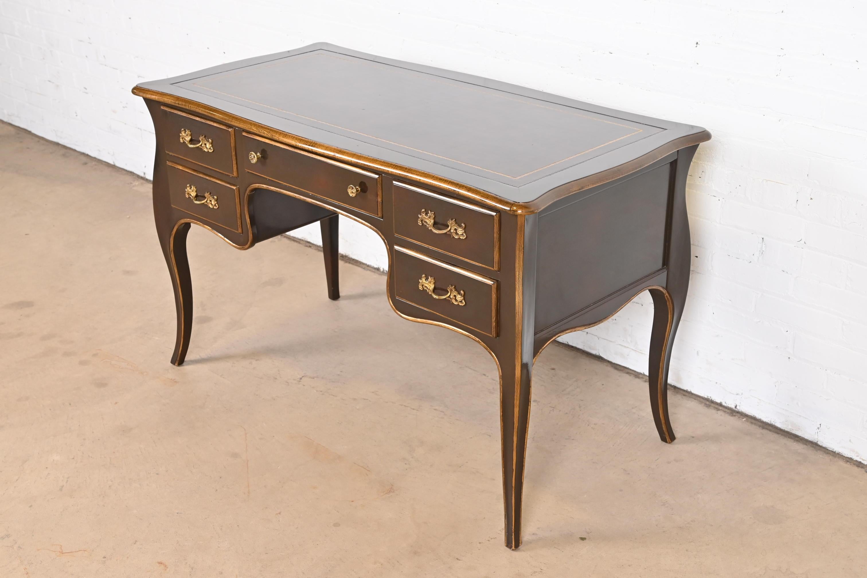 An exceptional French Provincial Louis XV style bureau plat writing desk

By Jacques Bodart

USA, Circa 1960s

Mahogany, with gold gilt trim, embossed leather top, and original brass hardware.

Measures: 49.25