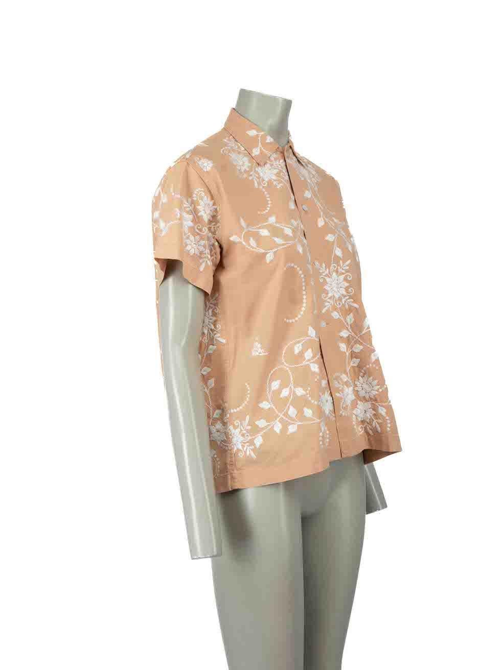 CONDITION is Very good. Minimal wear to shirt is evident. Minimal satin mark to front hemline on this used Bode designer resale item.
 
Details
Beige
Cotton
Shirt
White floral embroidery
Short sleeves
Round neck
Button up fastening
 
Made in India
