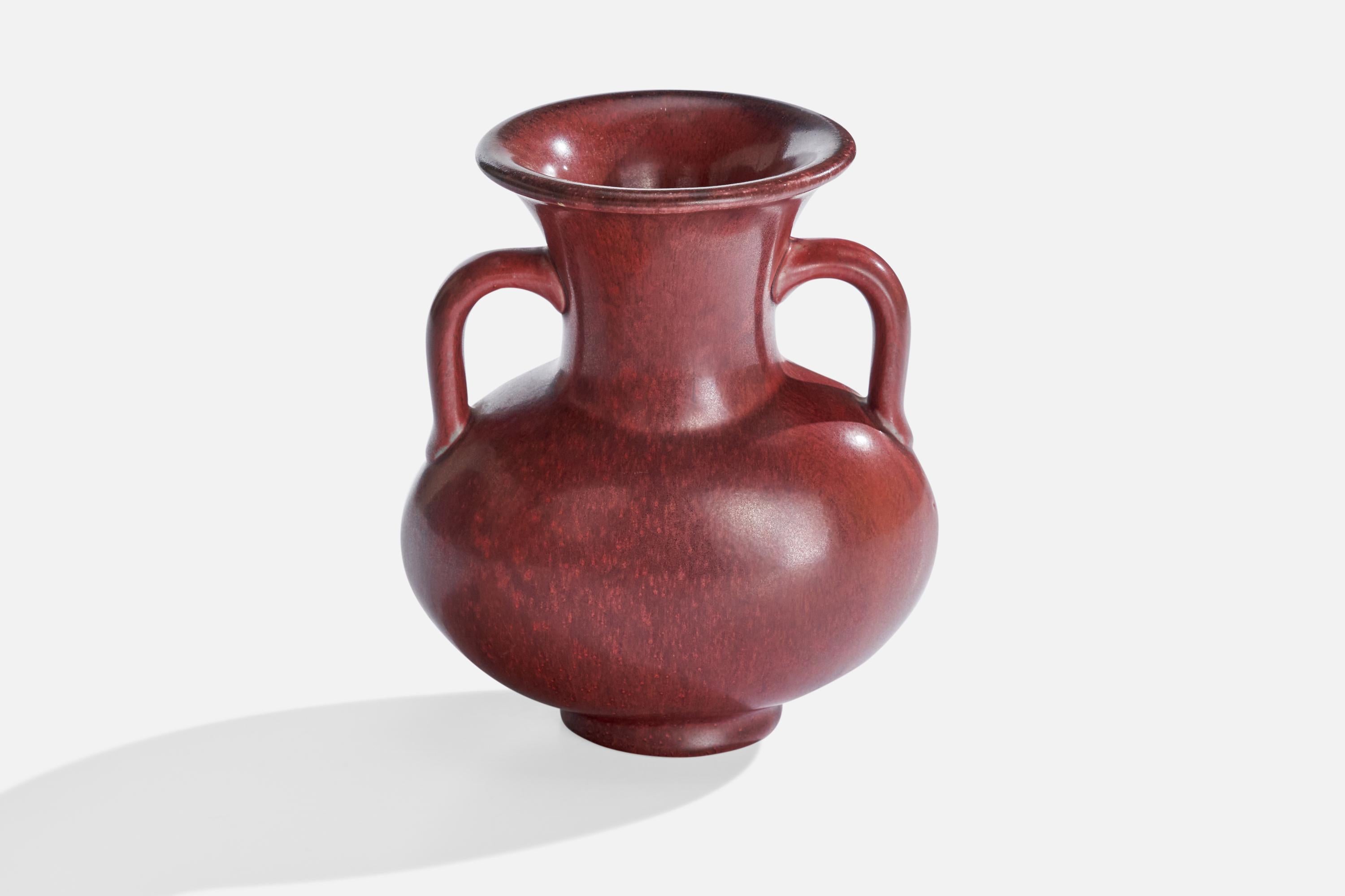 A red-glazed stoneware vase designed by Bode Willumsen and produced by Royal Copenhagen, Denmark, 1940s.