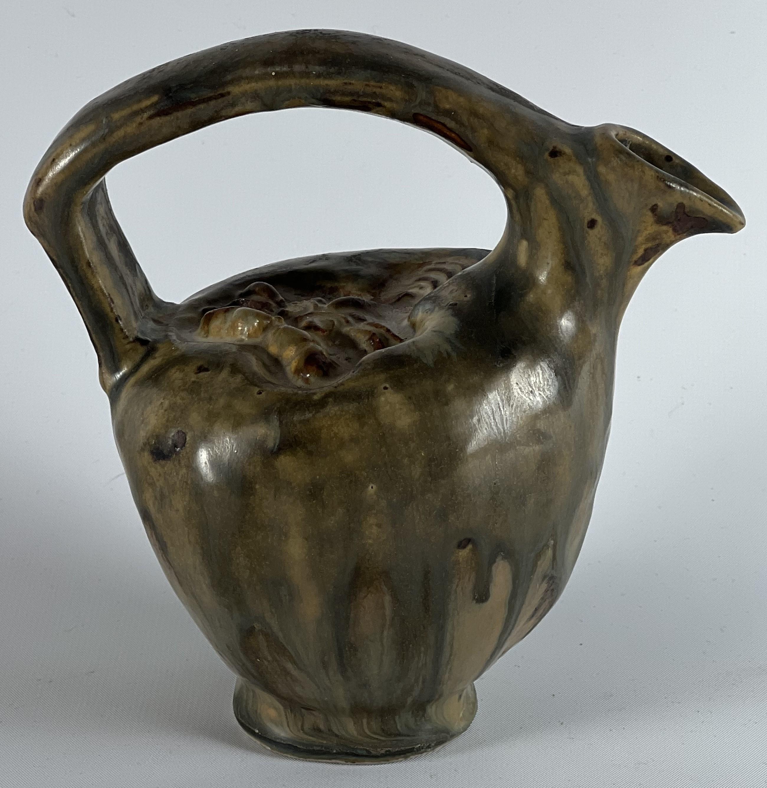 Bode Willumsen operated his own studio in Denmark and his work during the early period was celebrated to such an extent that he was hired at Royal Copenhagen where his related  designs were equally well received and acclaimed world wide.  This jug