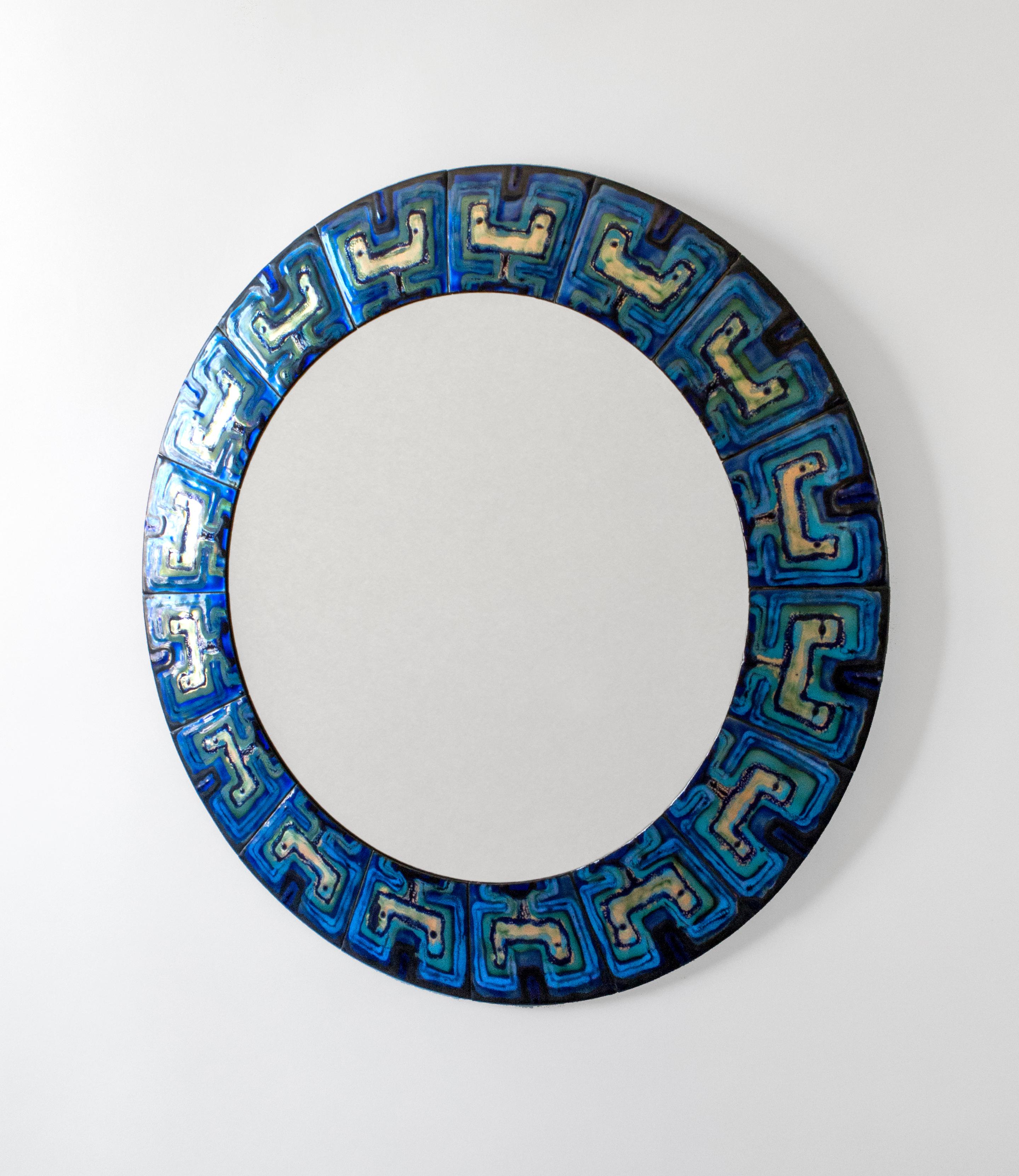 Composed of enameled copper plates hand-painted by the Danish artist Bodil Eje. The repeating pattern displays richly variegated blues enclosing colorless enamel reserves, surrounding a colorless glass mirror plate.

A vivid, sublime, and unique