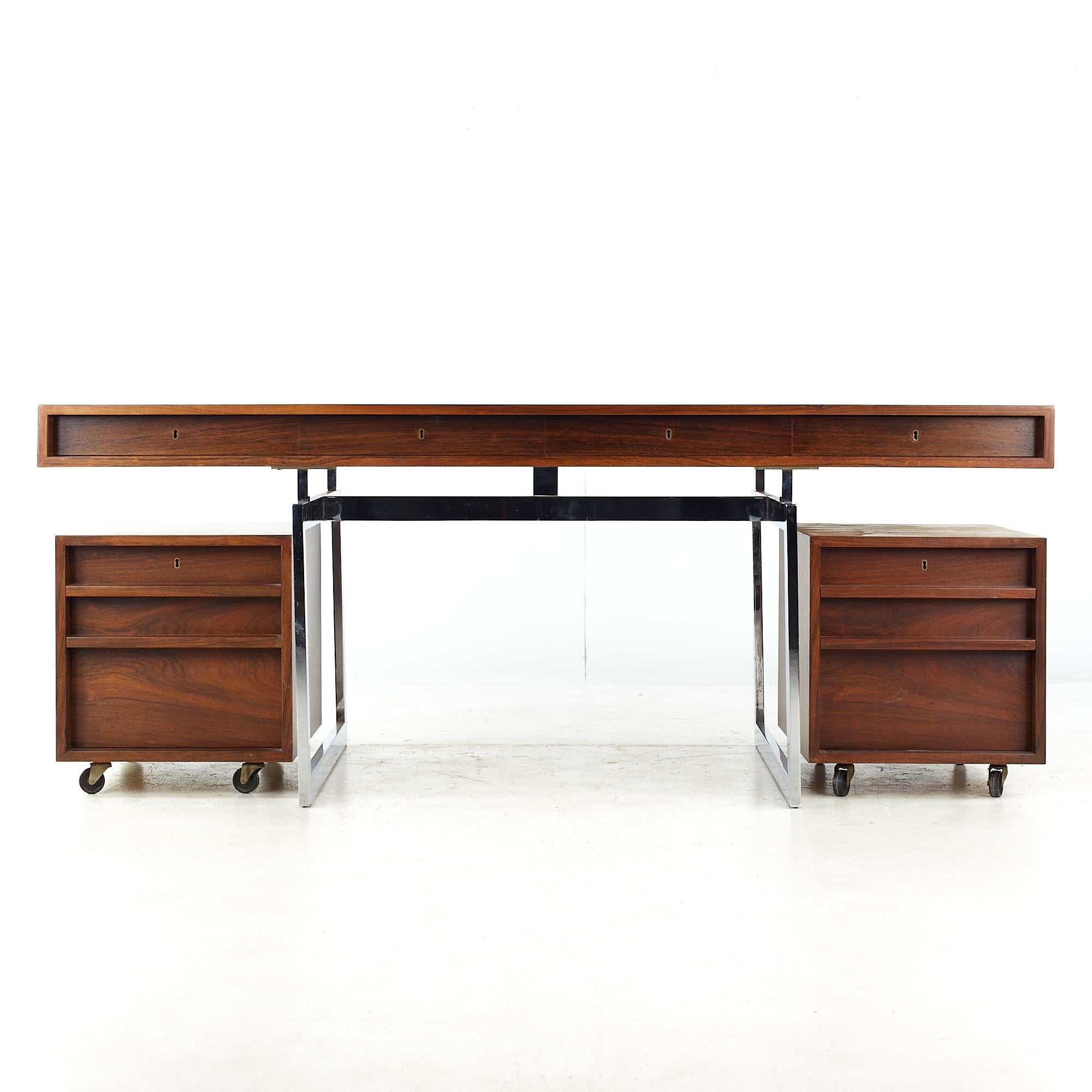 Bodil Kjaer for E. Pedersen & Son Mid Century Brazilian Rosewood and Chrome Desk

This desk measures: 72.75 wide x 38 deep x 28.75 high, with a chair clearance of 24.25 inches

All pieces of furniture can be had in what we call restored vintage