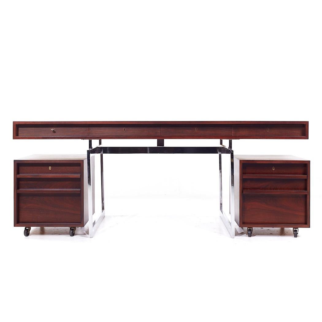 Bodil Kjaer for E. Pedersen & Son Mid Century Brazilian Rosewood and Chrome Desk

This desk measures: 72.75 wide x 38 deep x 28.75 high, with a chair clearance of 24.25 inches

All pieces of furniture can be had in what we call restored vintage