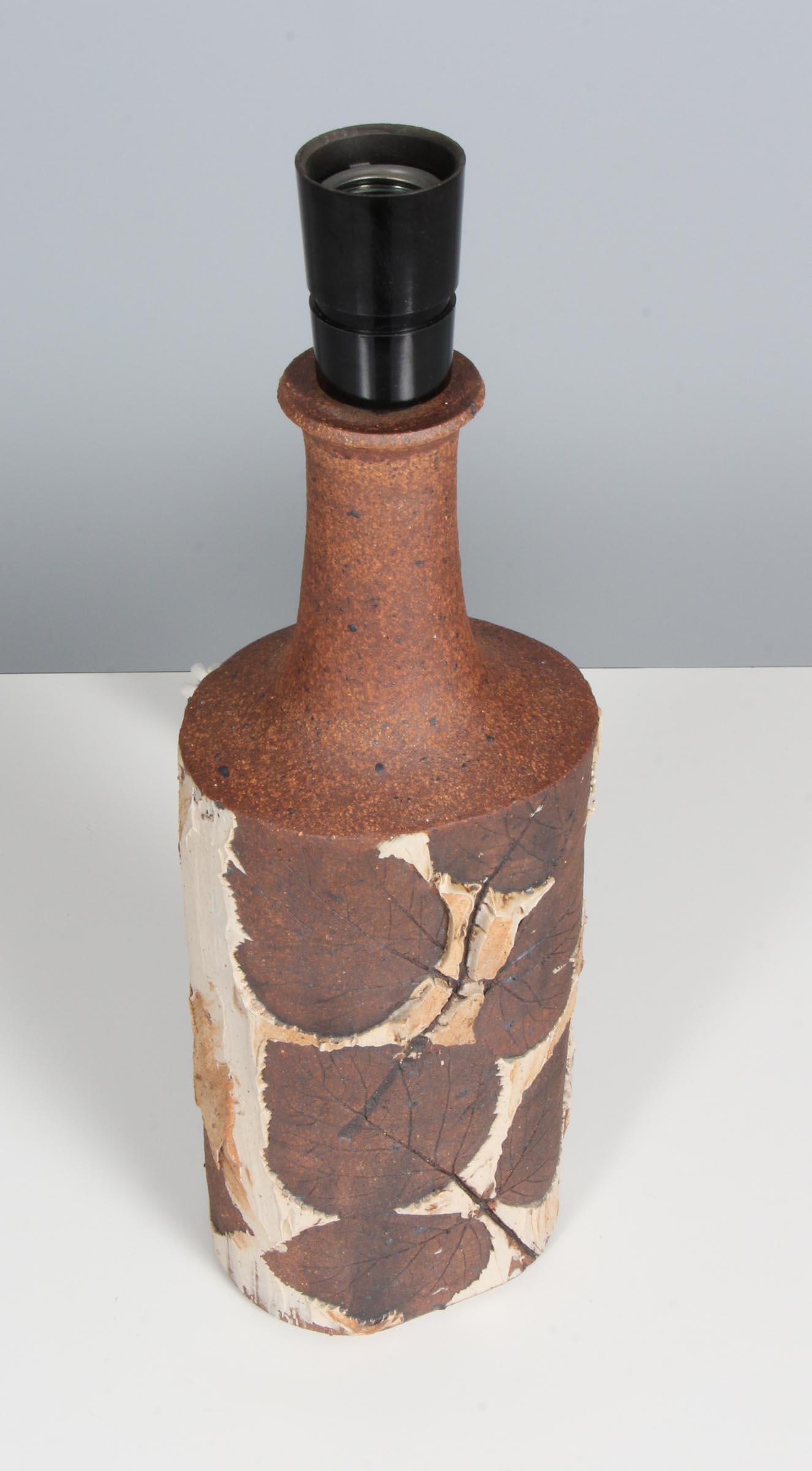 Bodil Marie Nielsen partly glazed stoneware table lamp with floral decoration from leafes. 

Made in Denmark in the 1970s.
